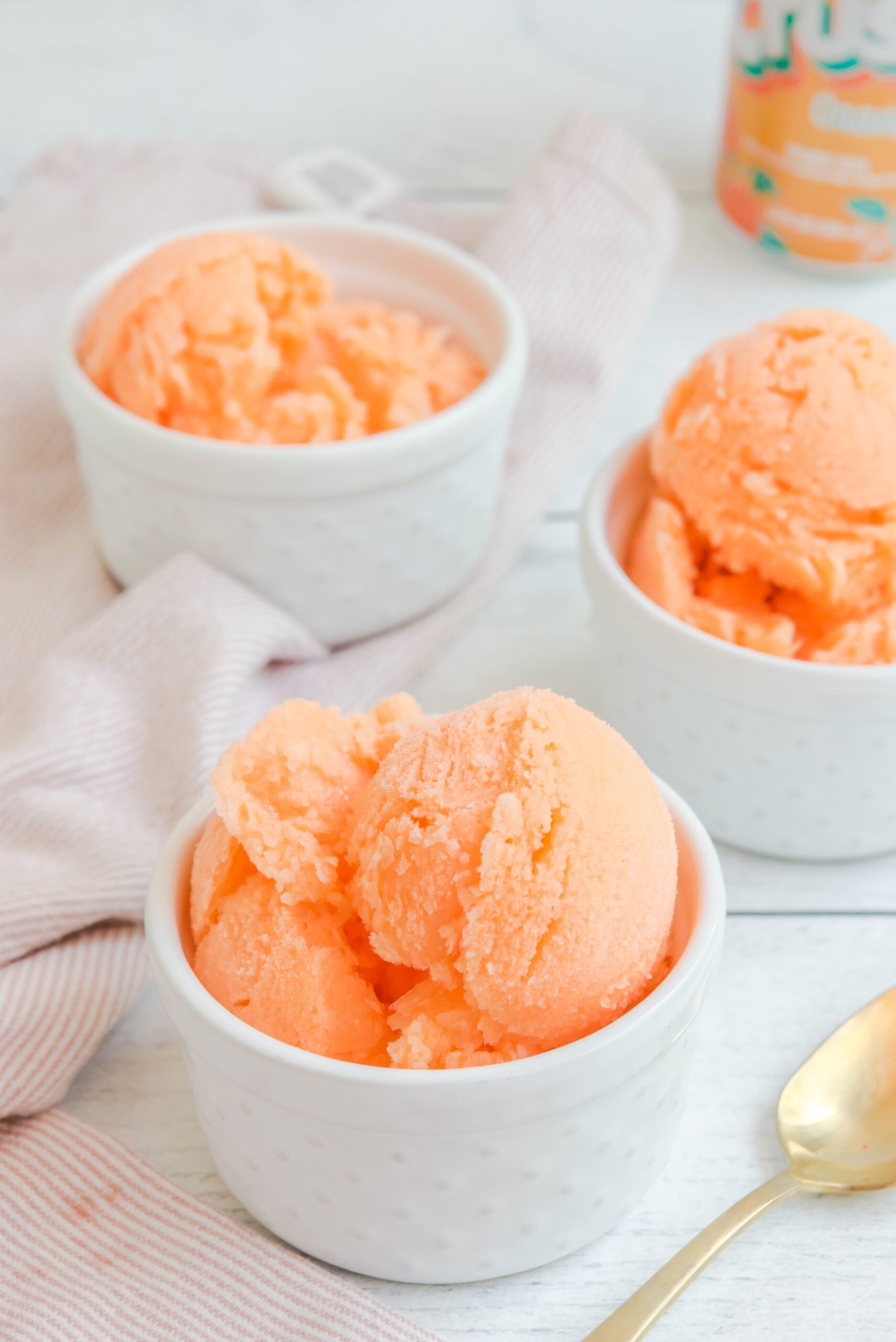 Orange Crush Sherbet in three white bowls