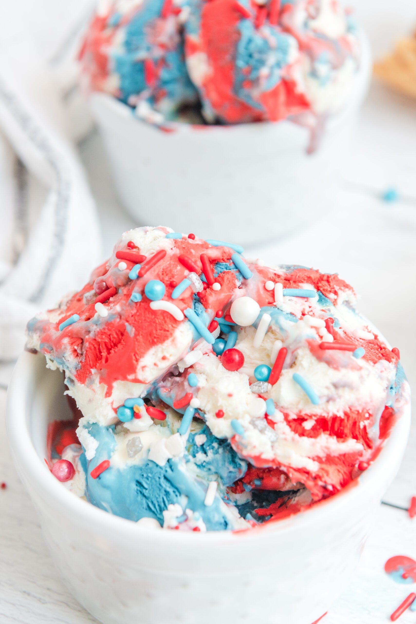 Red, White & Blue Ice Cream in a white bowl with patriotic sprinkles on top