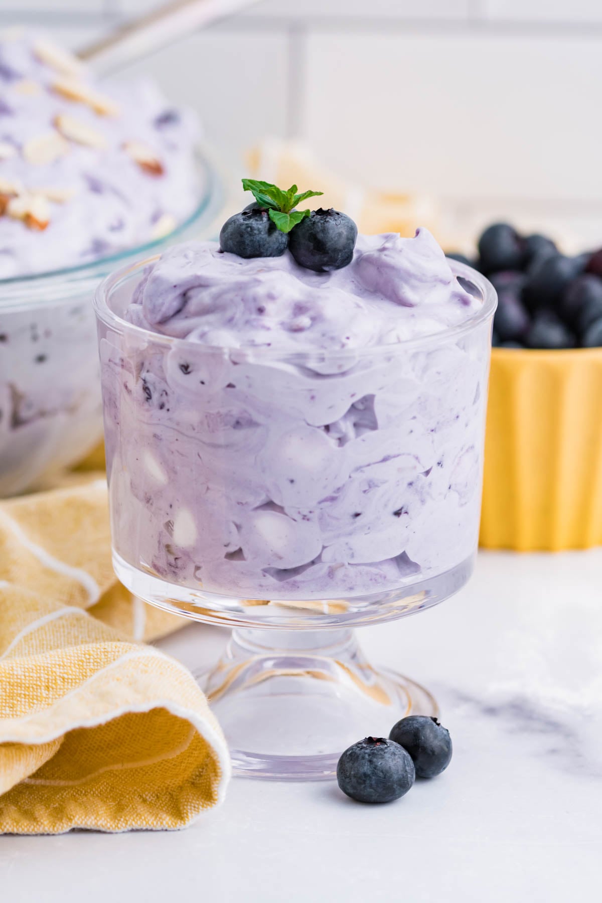 Blueberry Fluff Salad in a clear glass mini trifle side angle