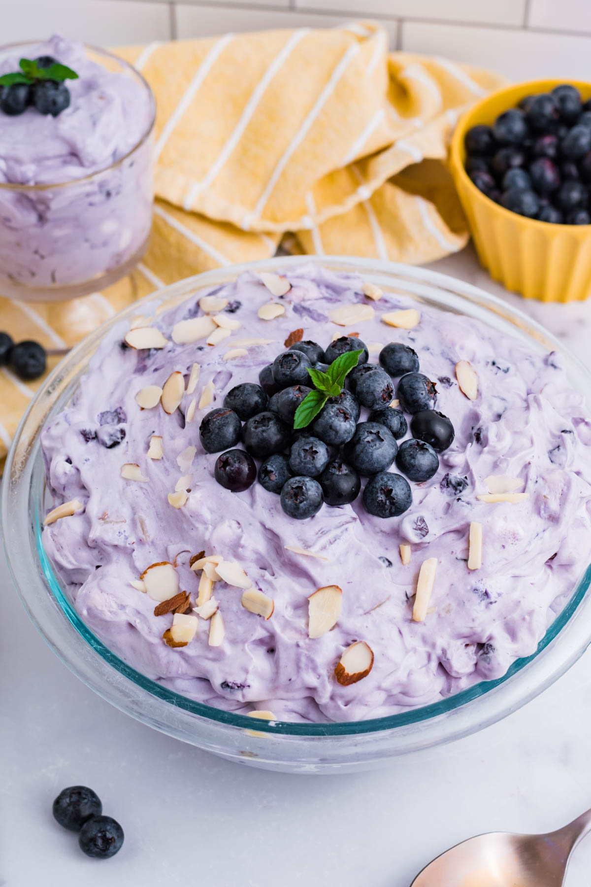 Blueberry Fluff Salad in a clear glass serving bowl