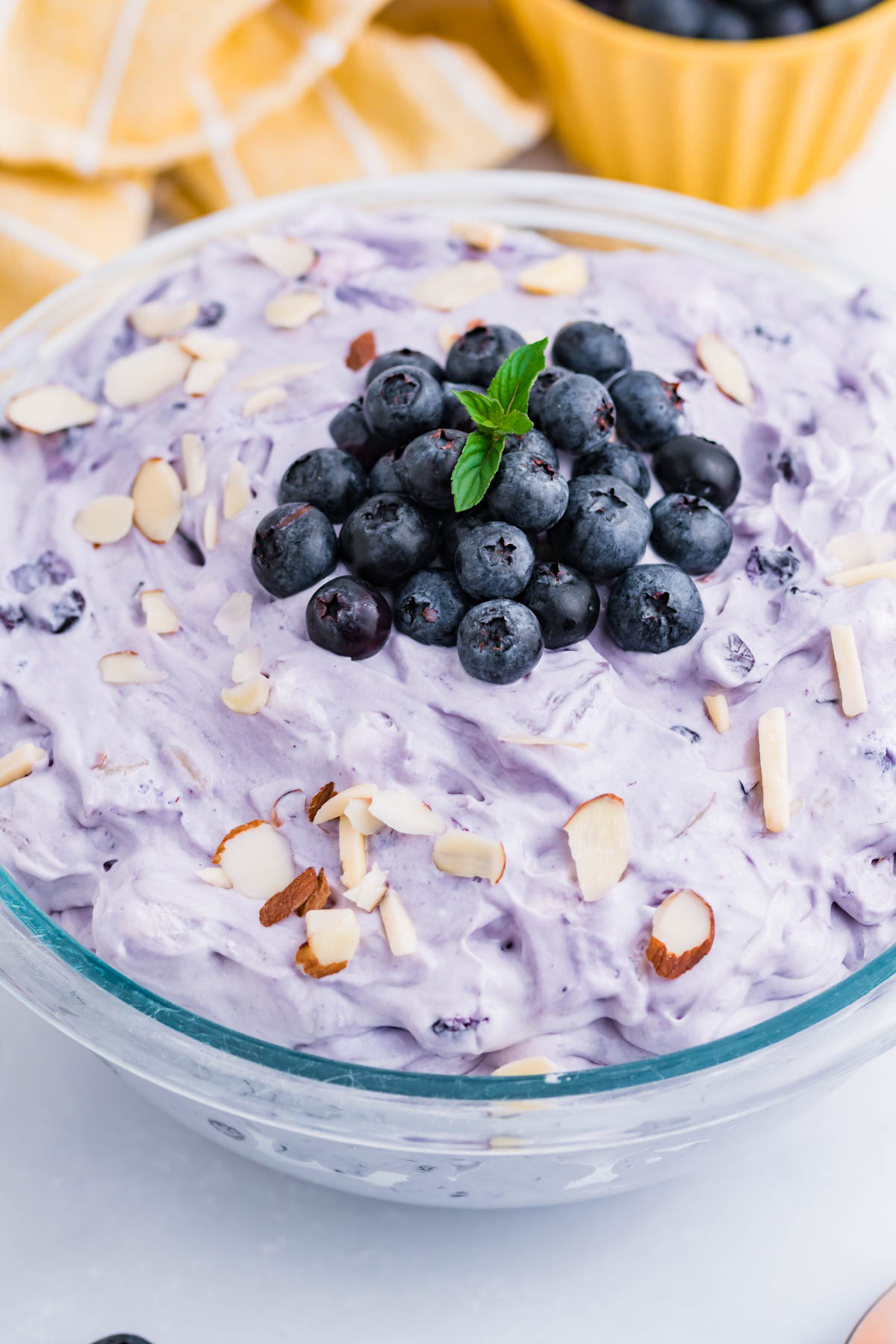 Blueberry Fluff Salad in a clear glass serving bowl overhead shot