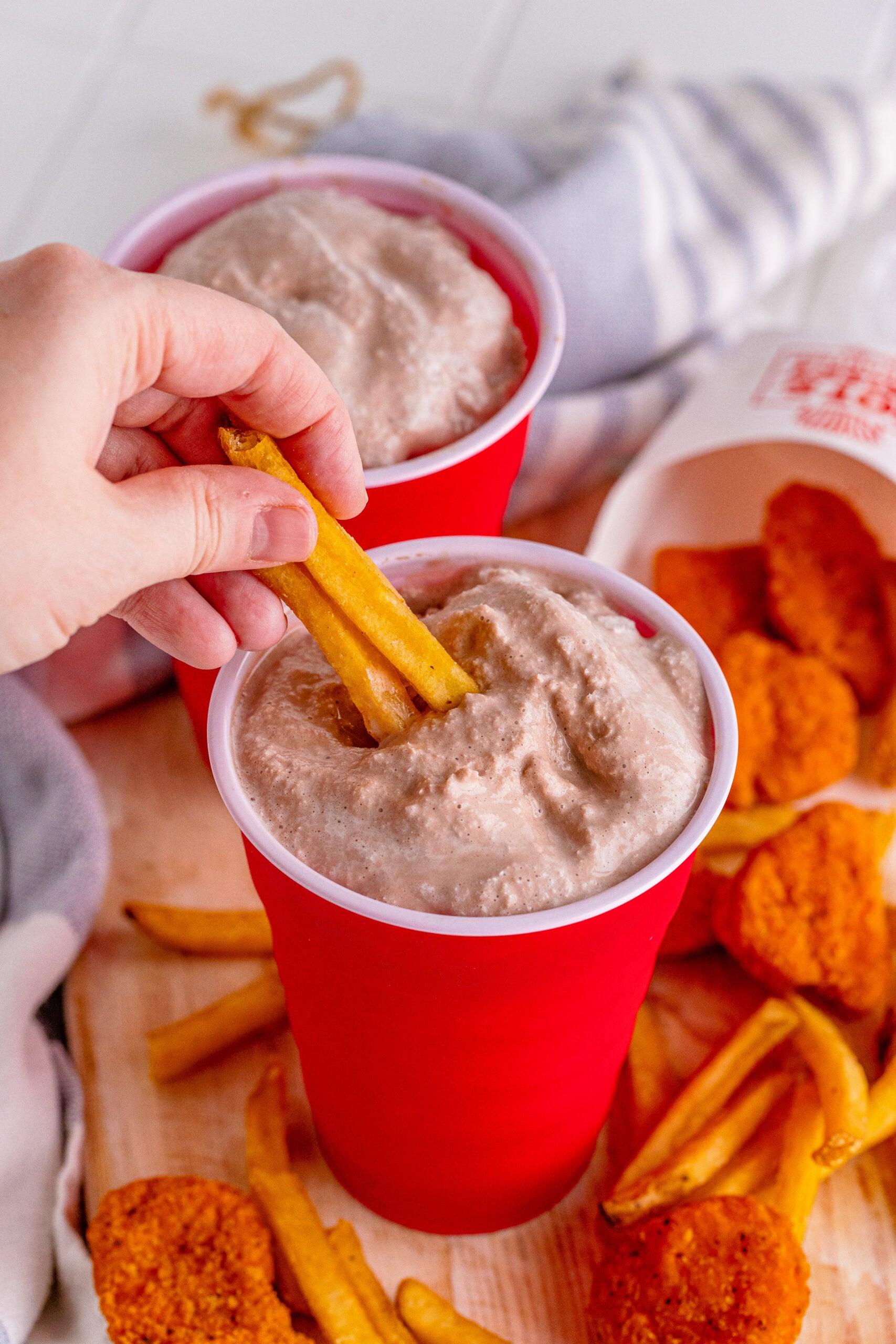 Wendys Frosty homemade in a red solo cup with fries being dipped into it