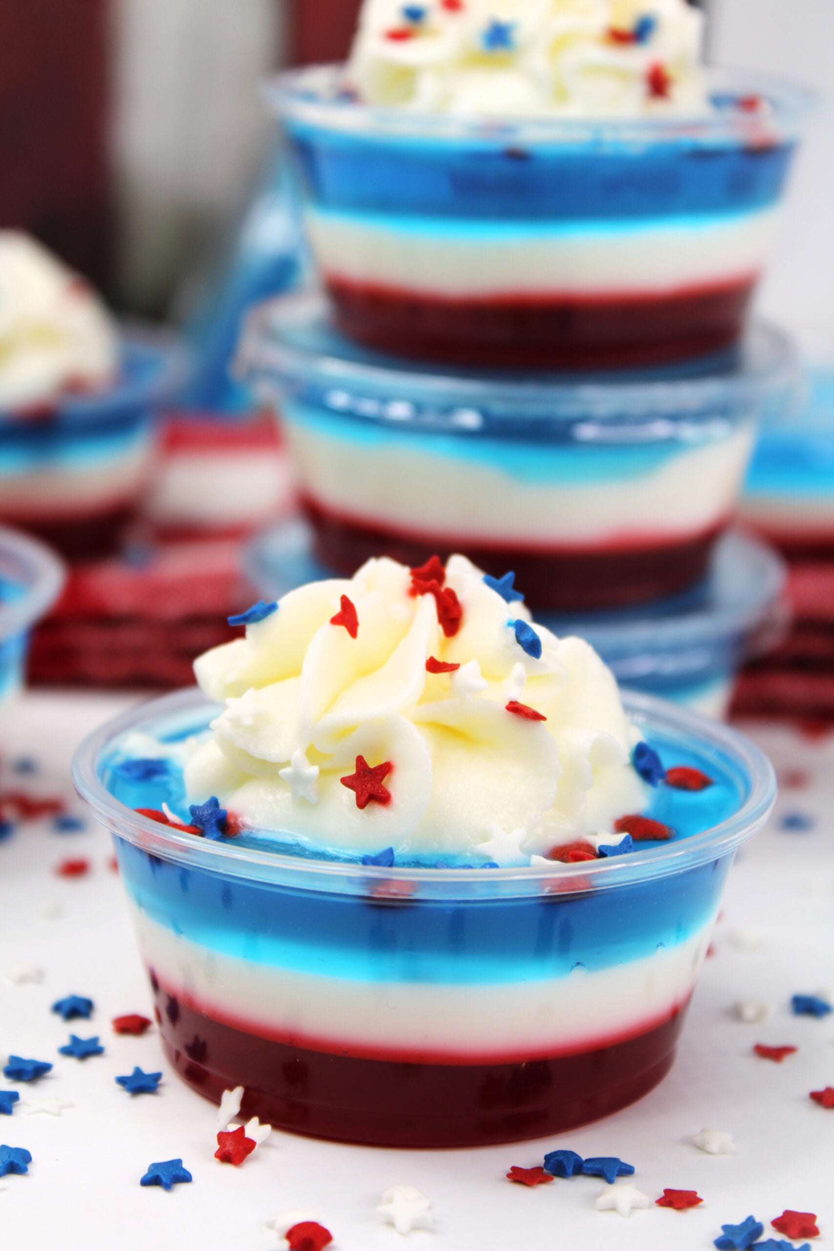 Bomb Pop Jello Shot layered red, white & blue topped with whipped cream