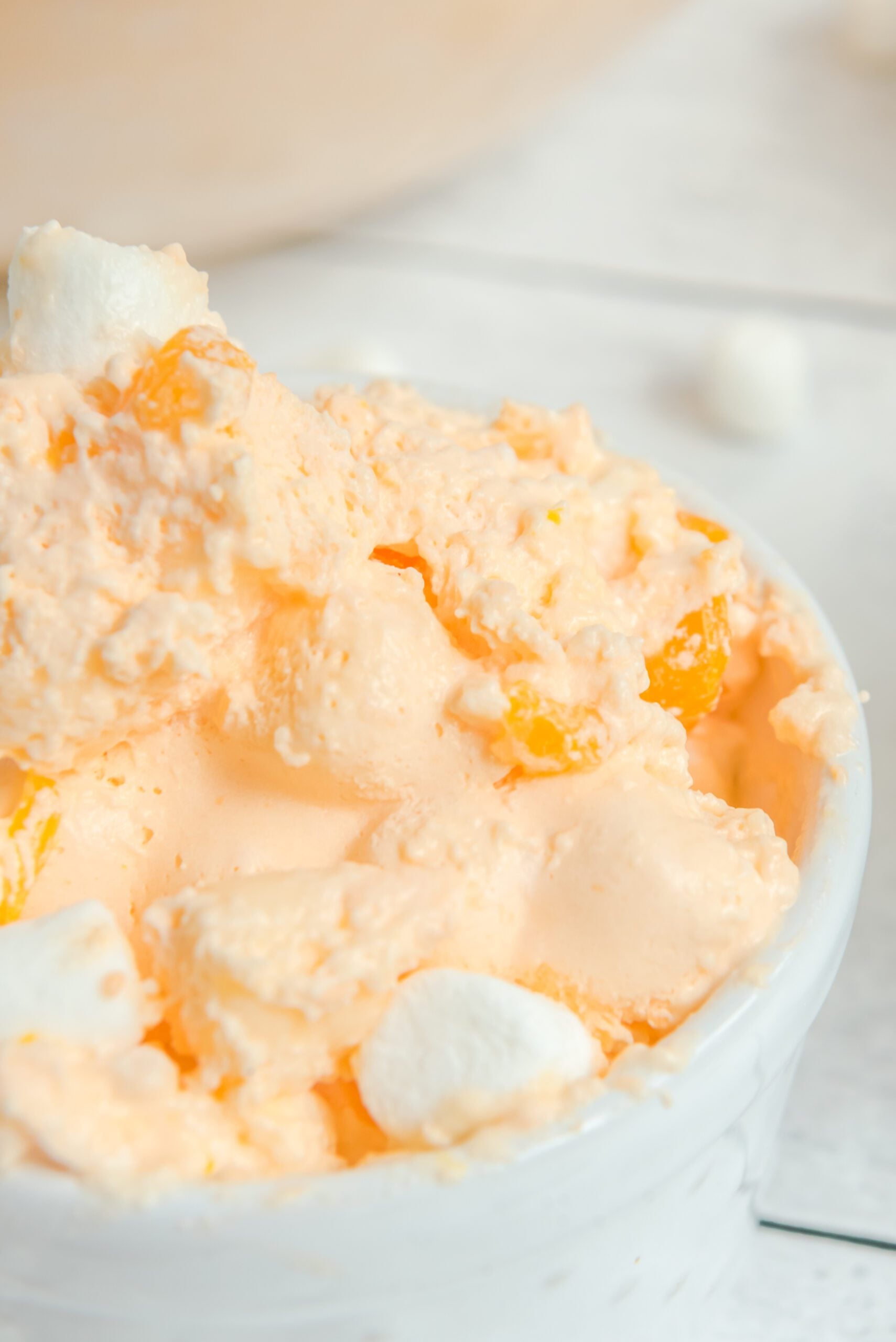 Orange Creamsicle Salad in a white serving bowl