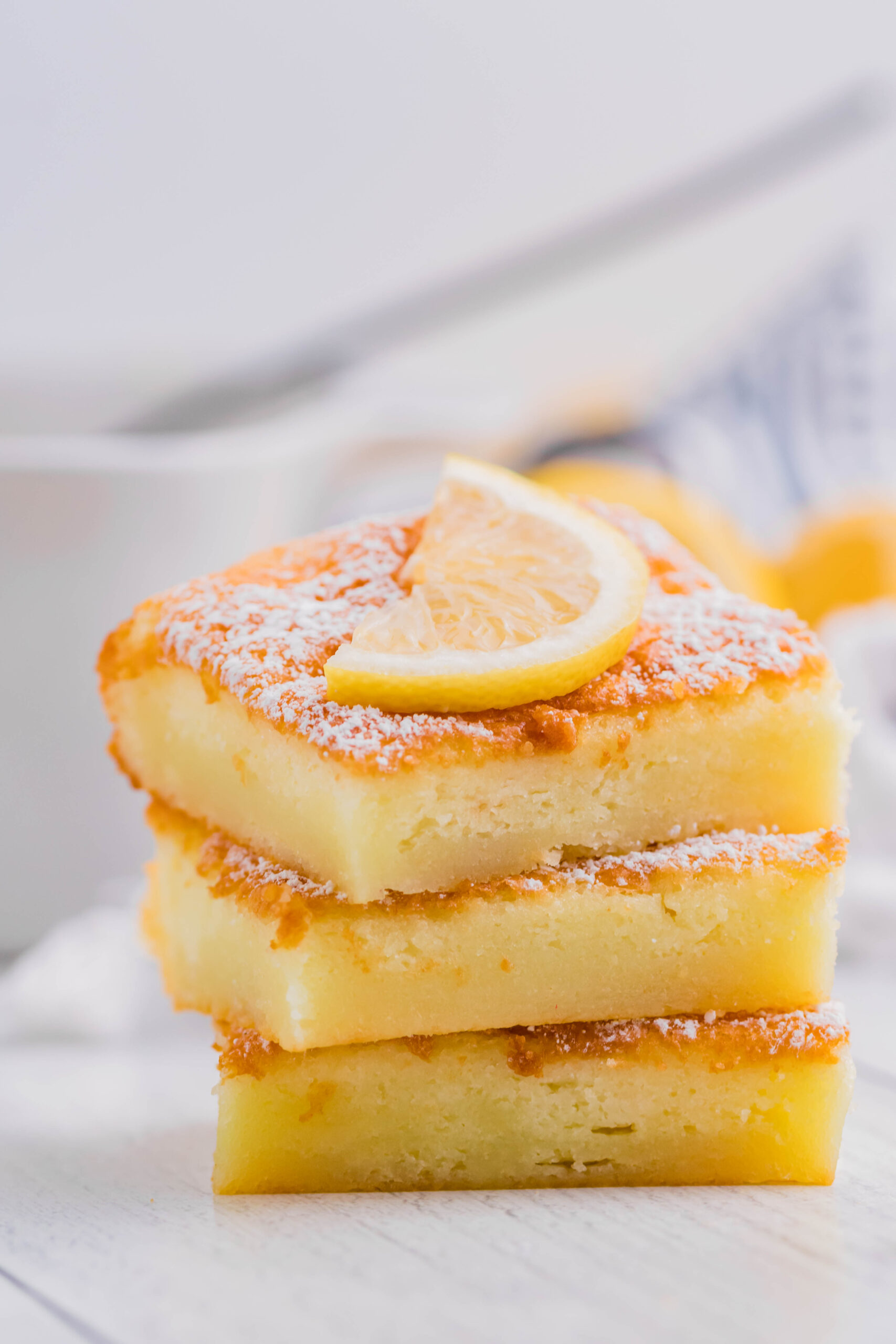 2 Ingredient Lemon Bars stacked on a white plate