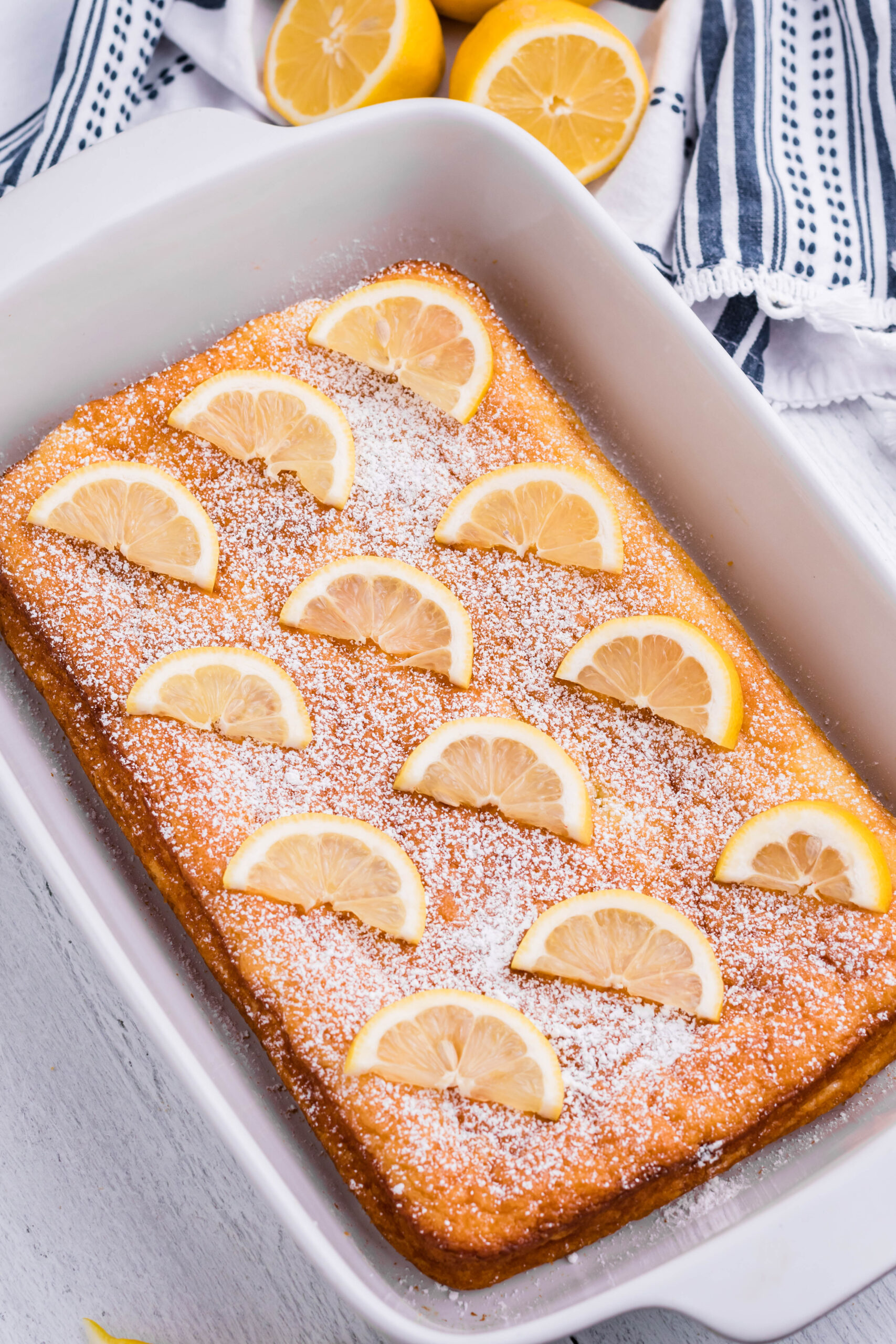 2 Ingredient Lemon Bars uncut in a white baking pan