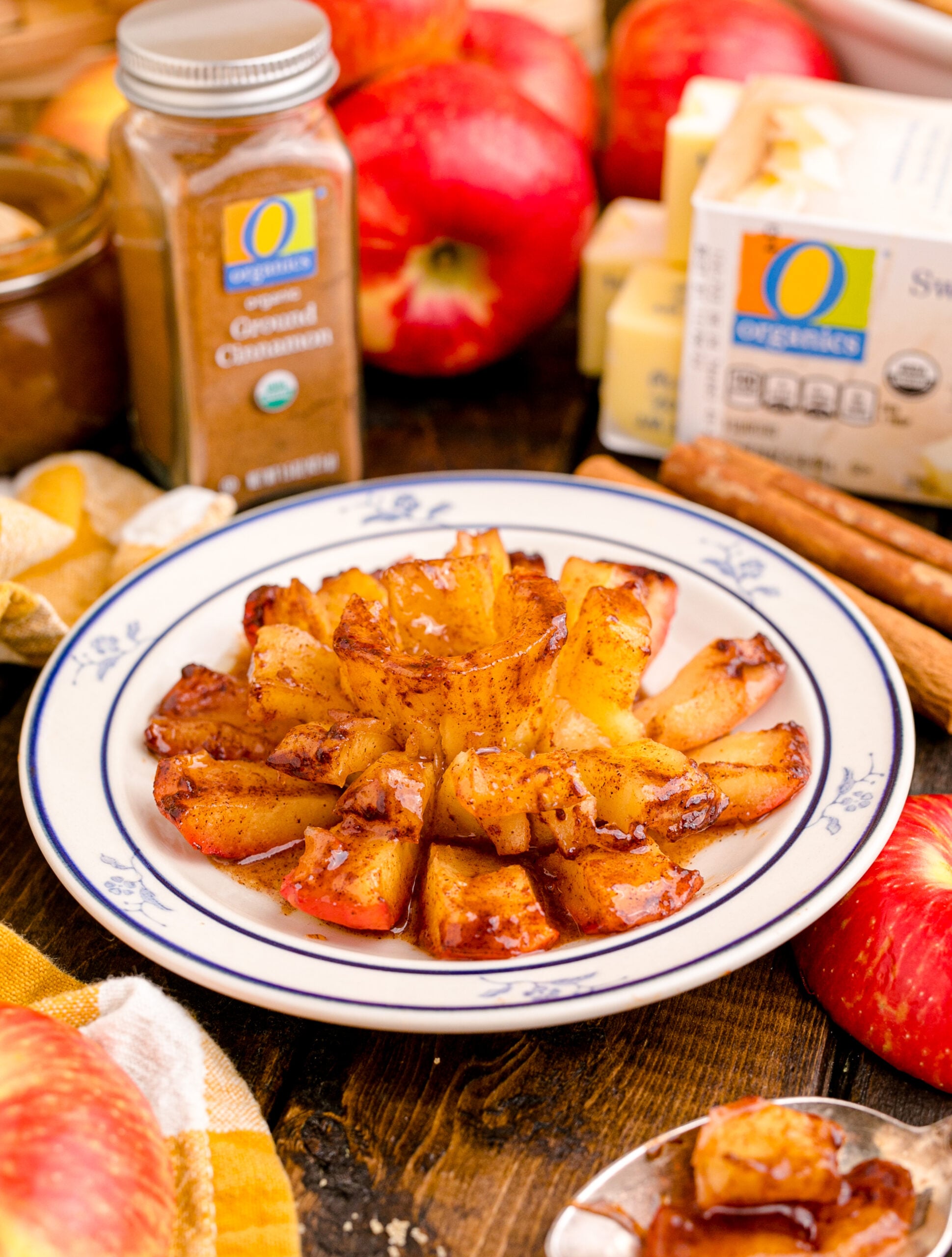 Oven Baked Bloomin Apples on a white plate on a wood table