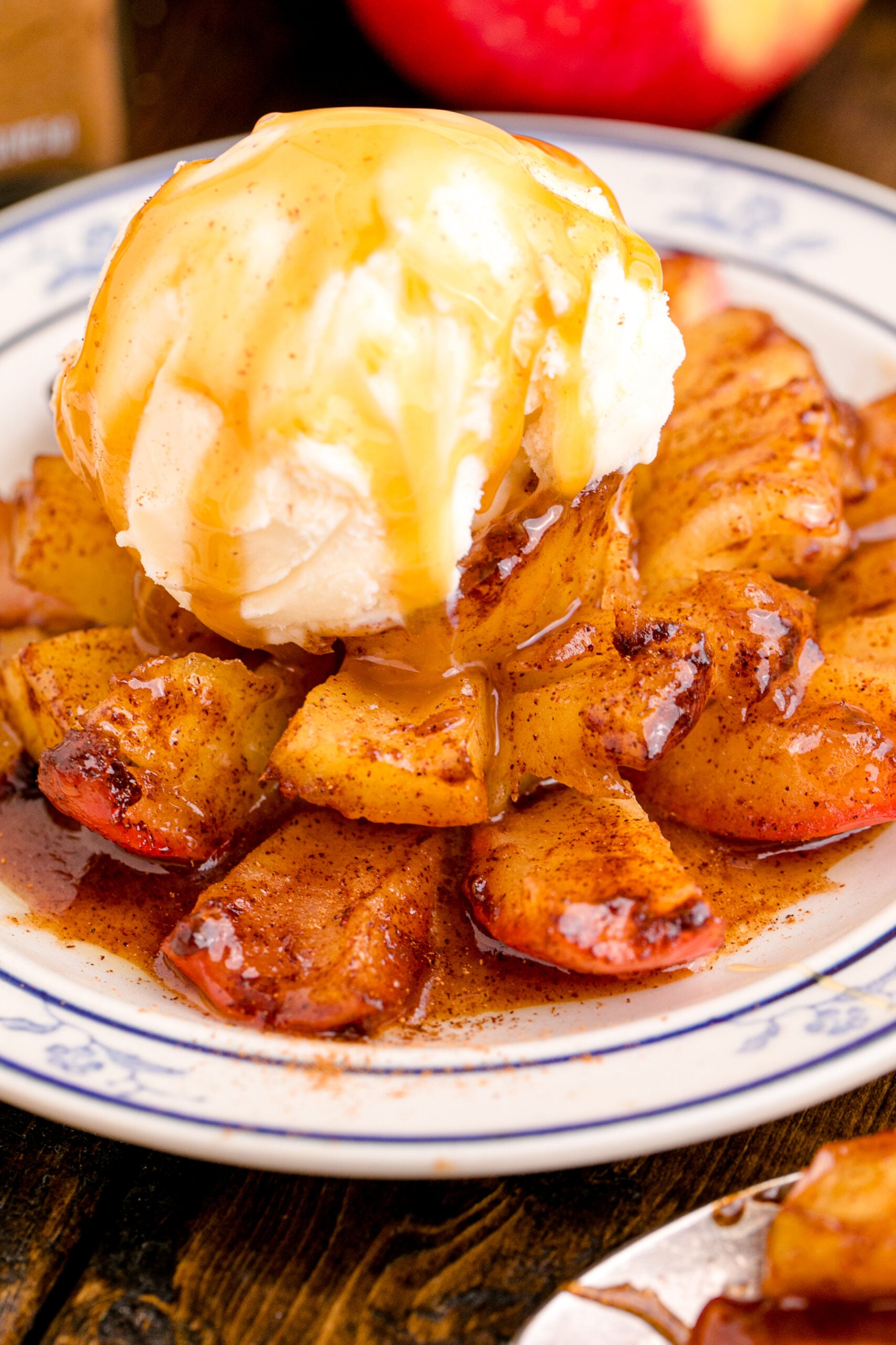 Oven Baked Bloomin Apples on a white plate topped with ice cream and caramel sauce