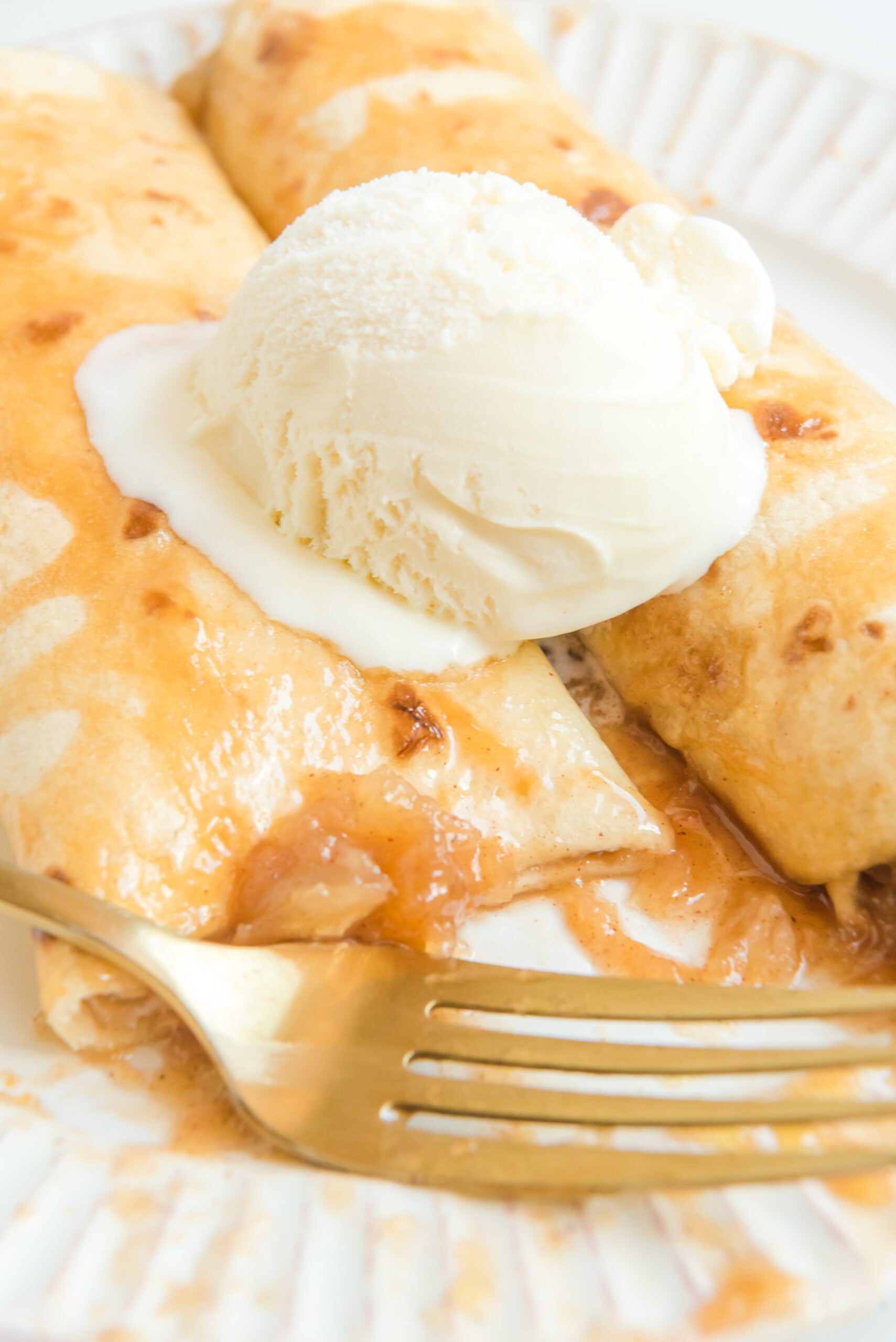 Apple Pie Enchiladas topped with vanilla ice cream