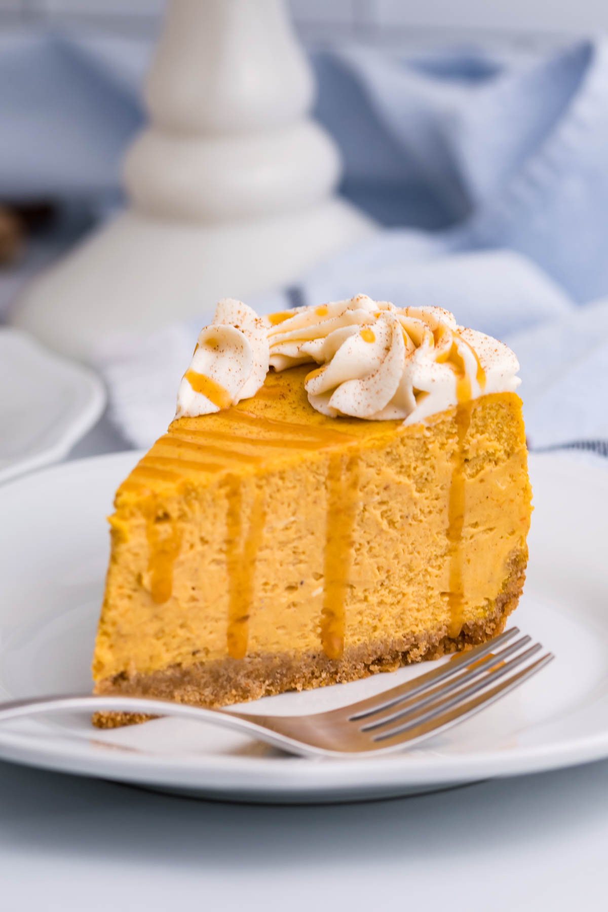Pumpkin Cheesecake on a white plate with a fork next to it