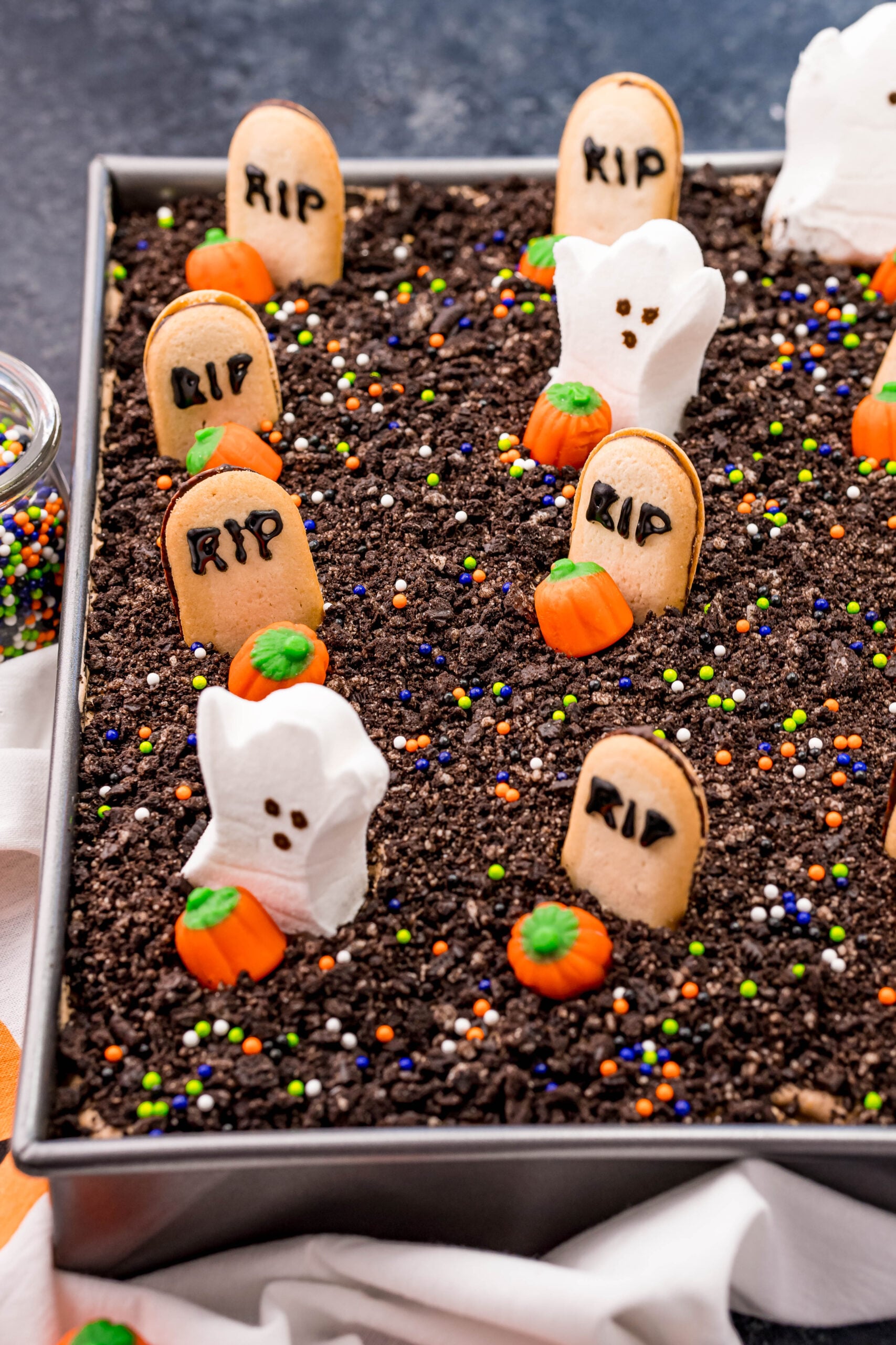 Halloween Dirt Cake in a sliver baking pan uncut