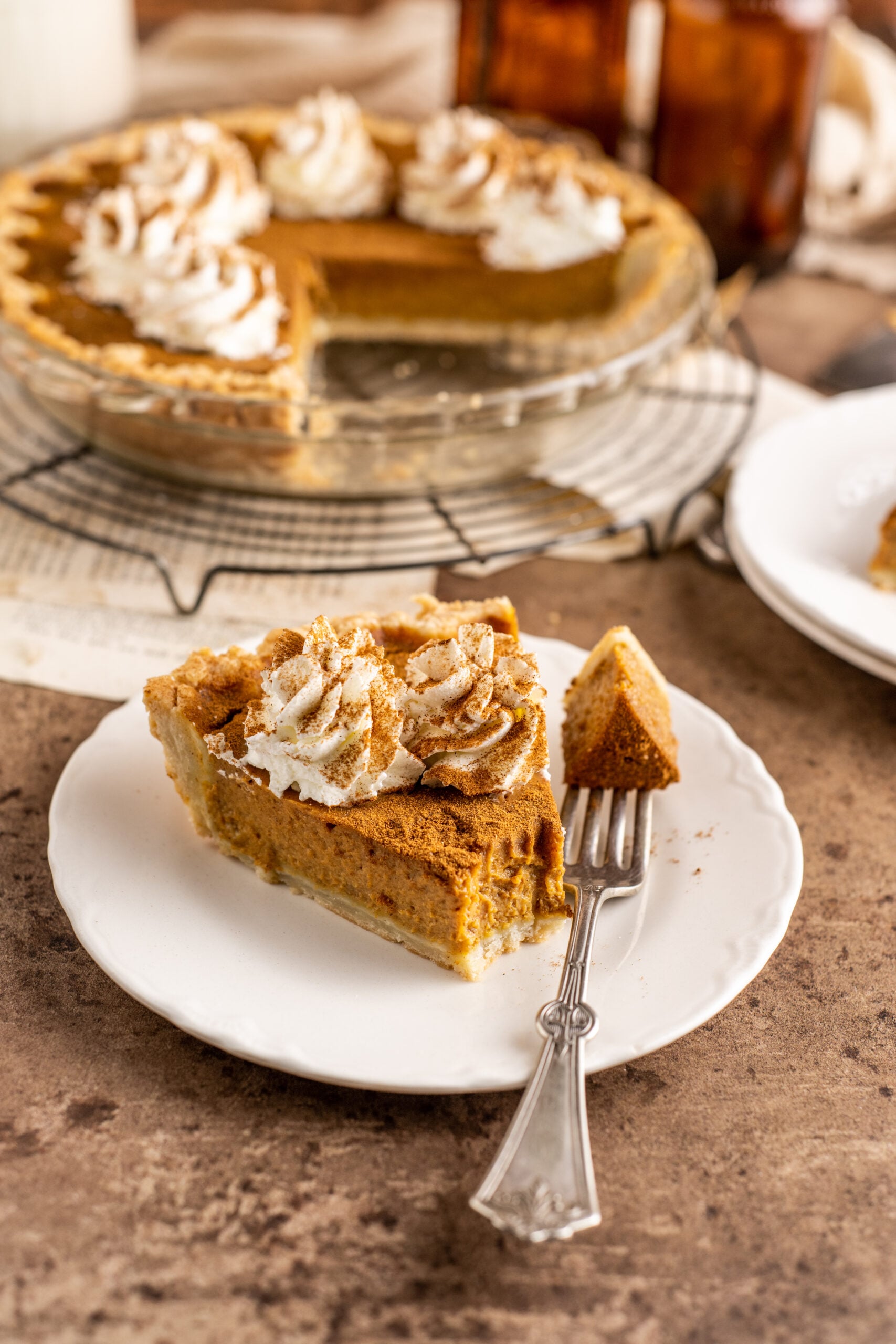 Pumpkin Custard Pie slice with a bite missing on a fork