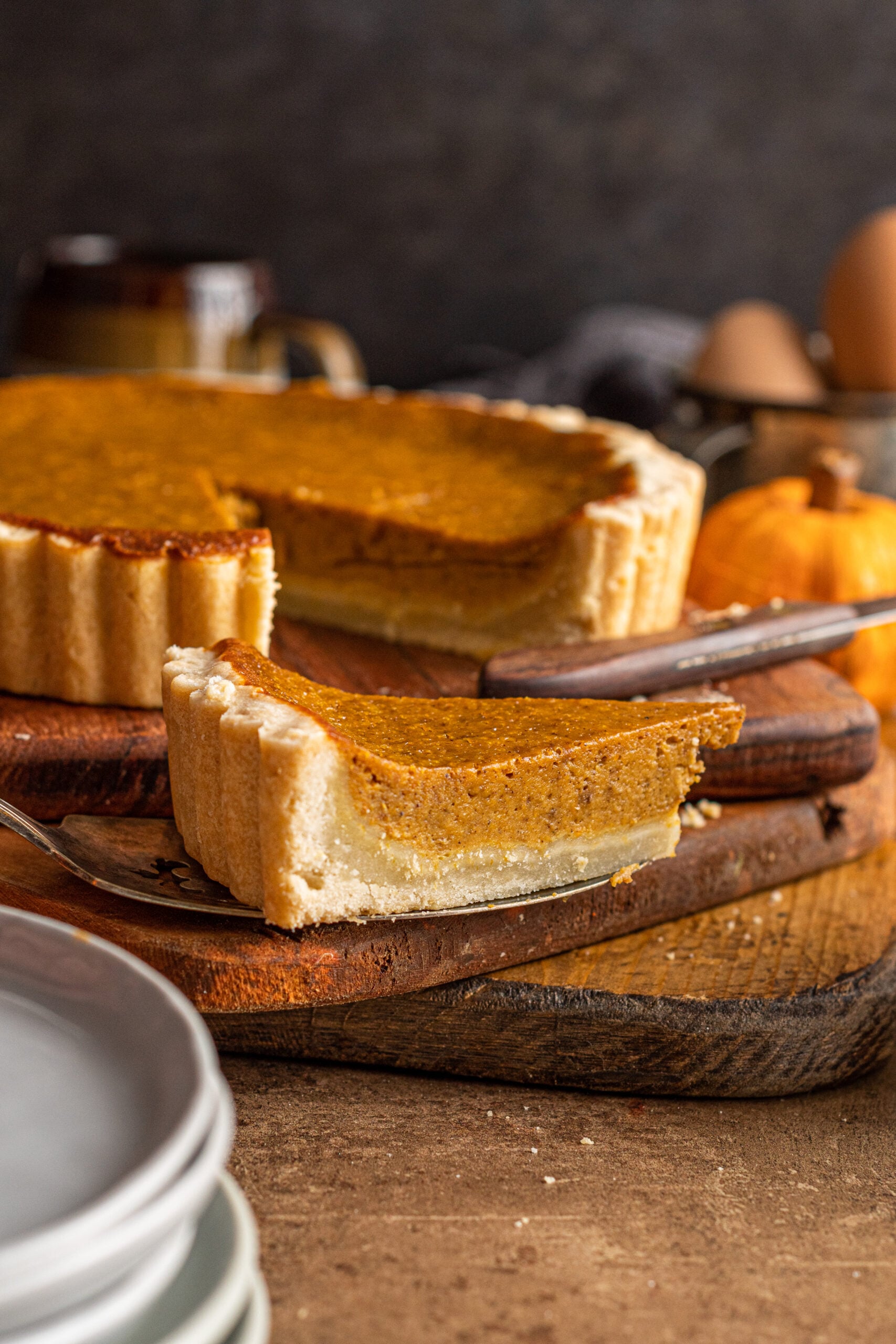 Pumpkin Pie Tart slice on a wooden cutting board