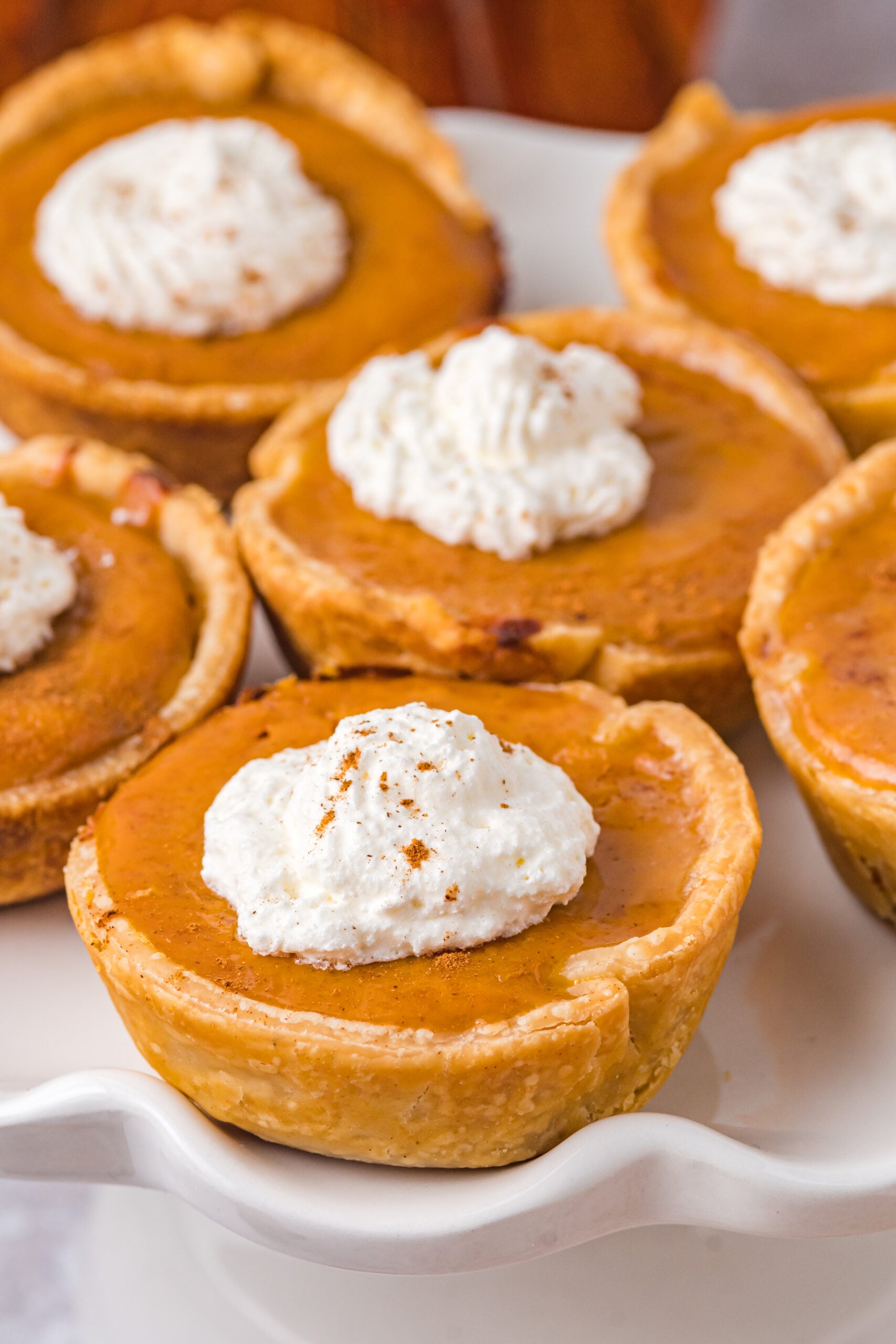 Mini Pumpkin Pies on a white serving platter close up shot