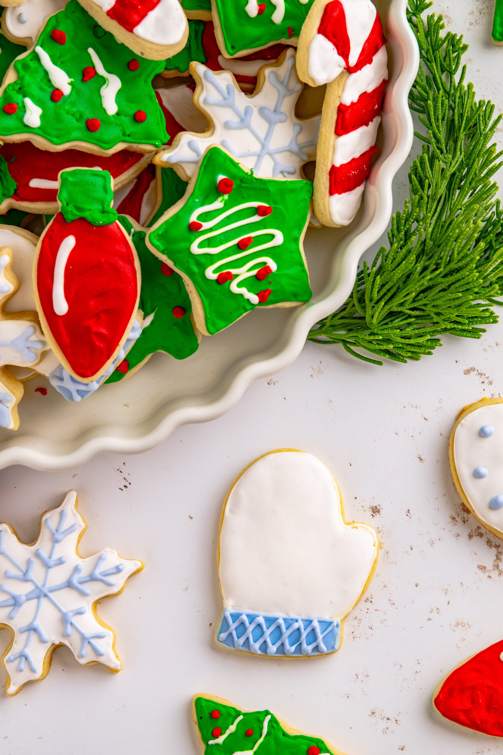 Above shot of a white and light blue Christmas mitten cookie.