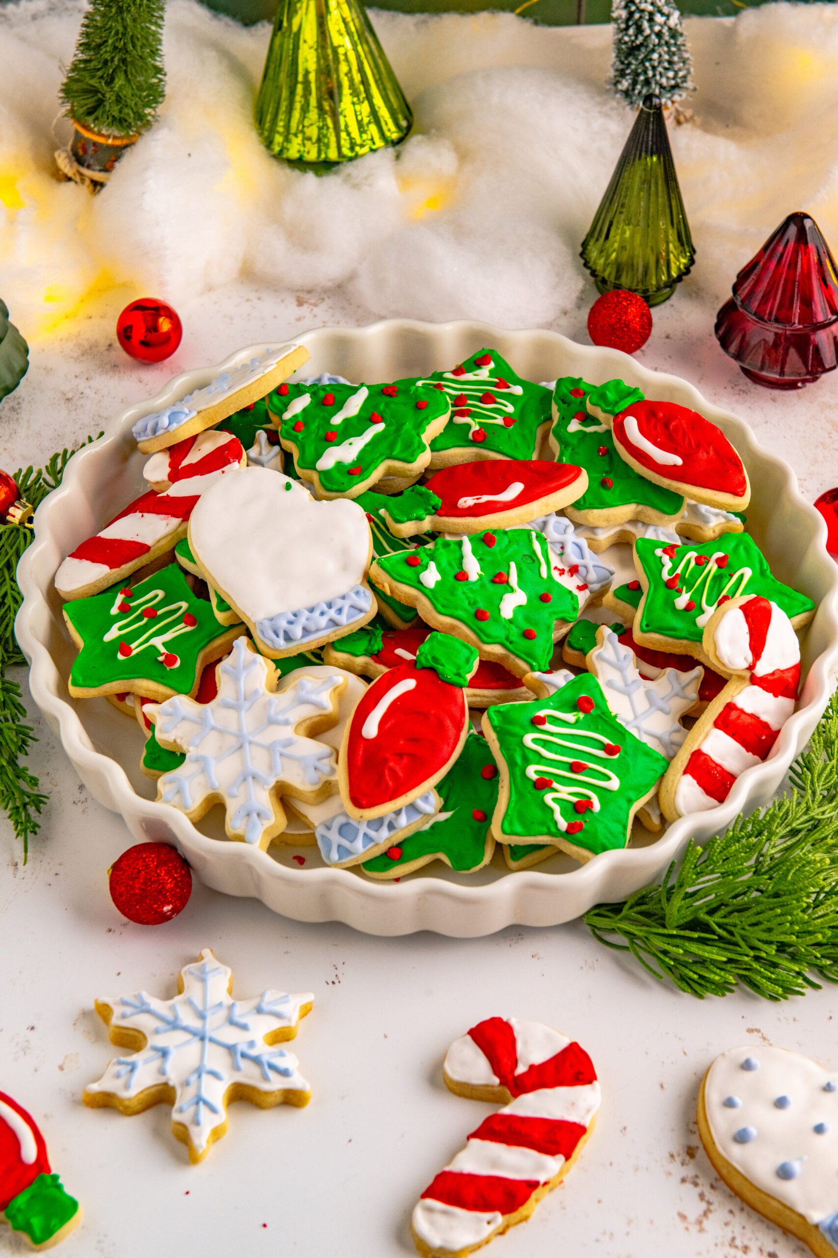 Christmas Sugar Cookies stacked on a white serving tray.