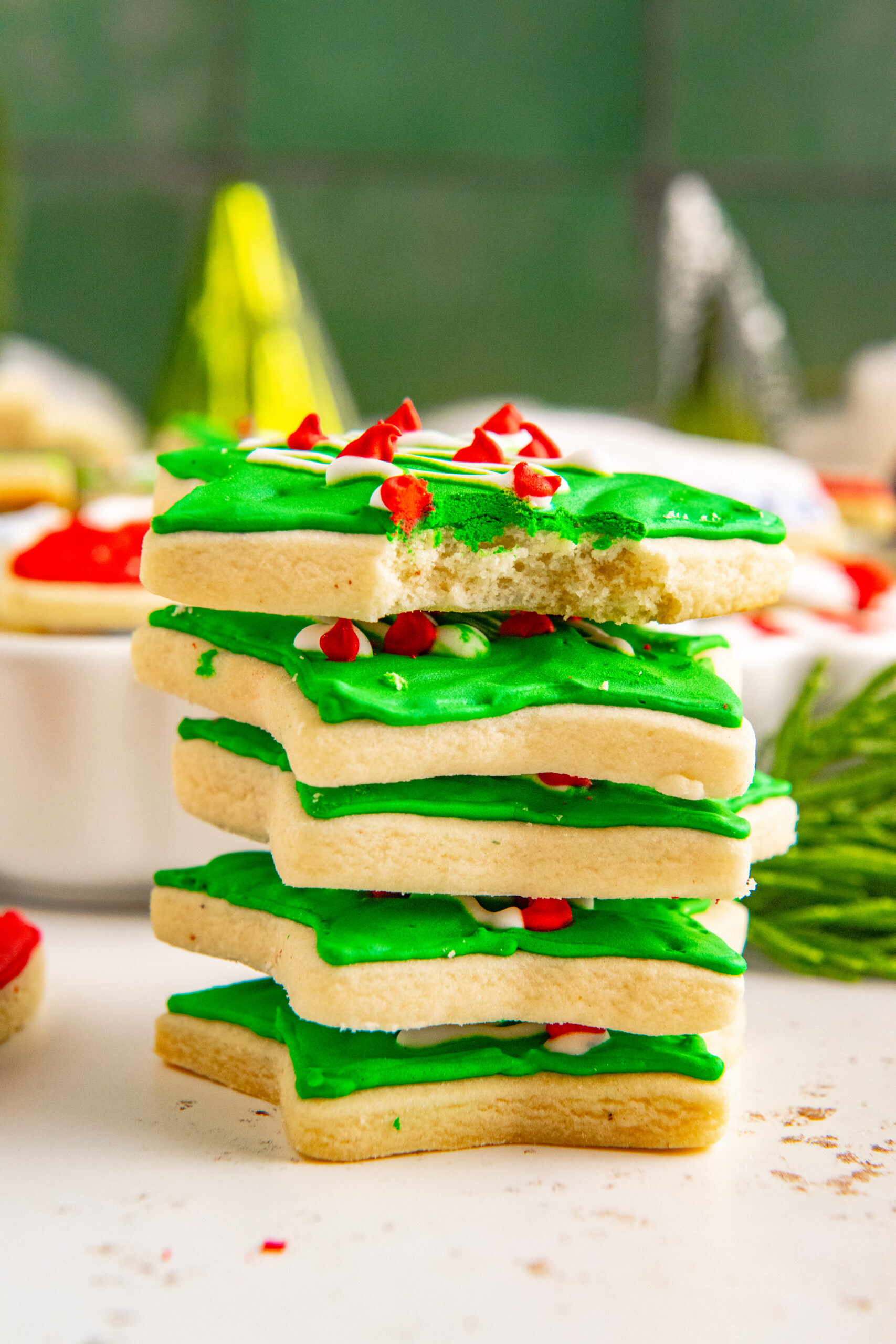 Five Christmas Cookies stacked with a bite removed from the top cookie showing the fluffy center.