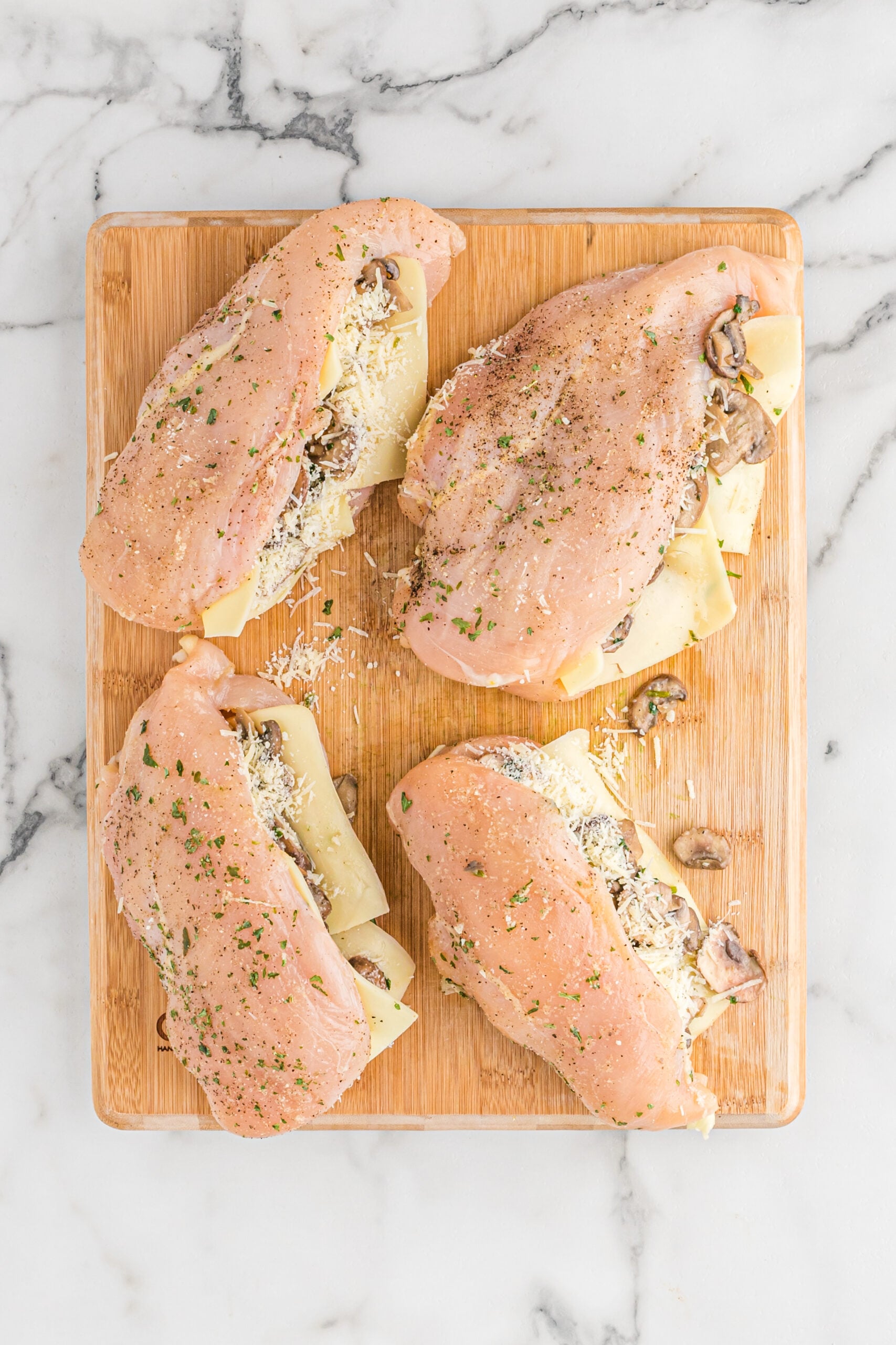 Overhead view of the raw chicken stuffed with ingredients. 