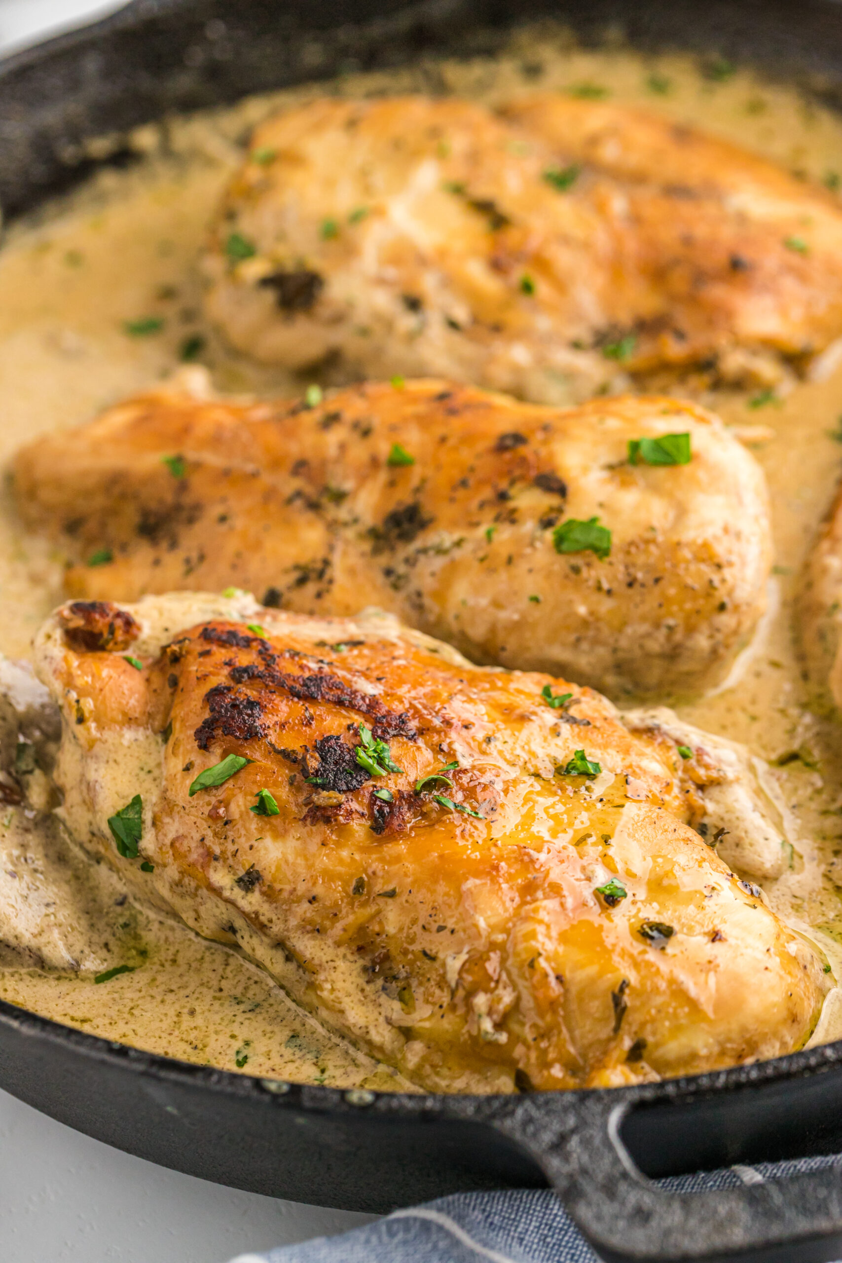 Cheesy Garlic Butter Mushroom Stuffed Chicken in a cast iron skillet. 