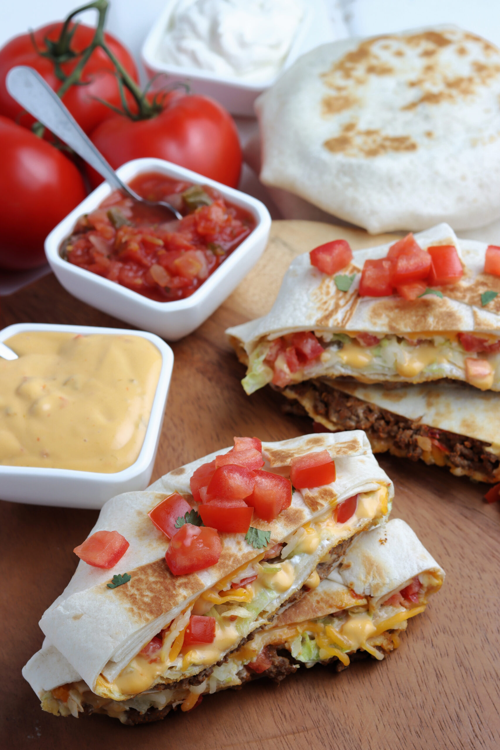 A crunch wrap cut in half and stacked showing the layers on the inside.