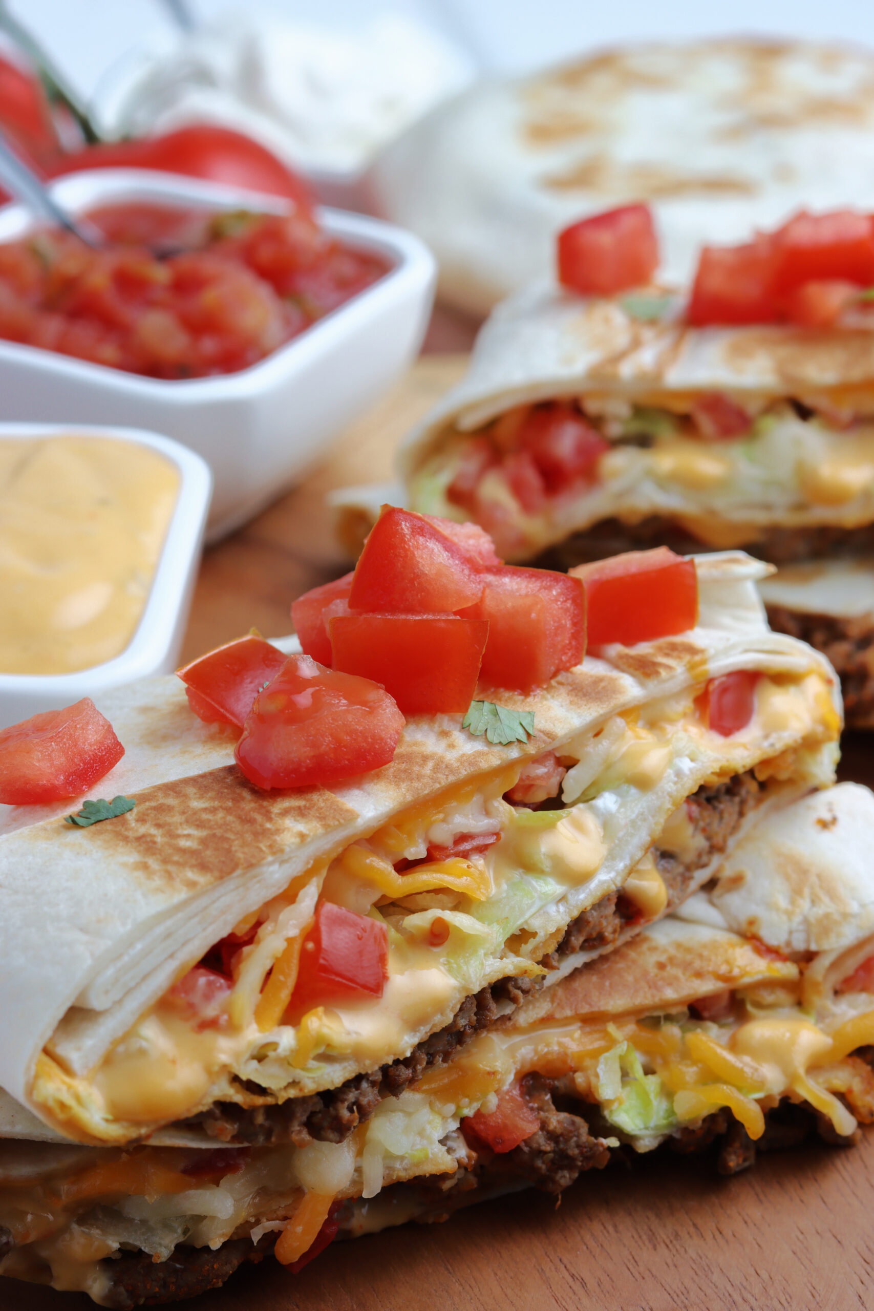 A crunch wrap cut in half and stacked showing the layers on the inside.