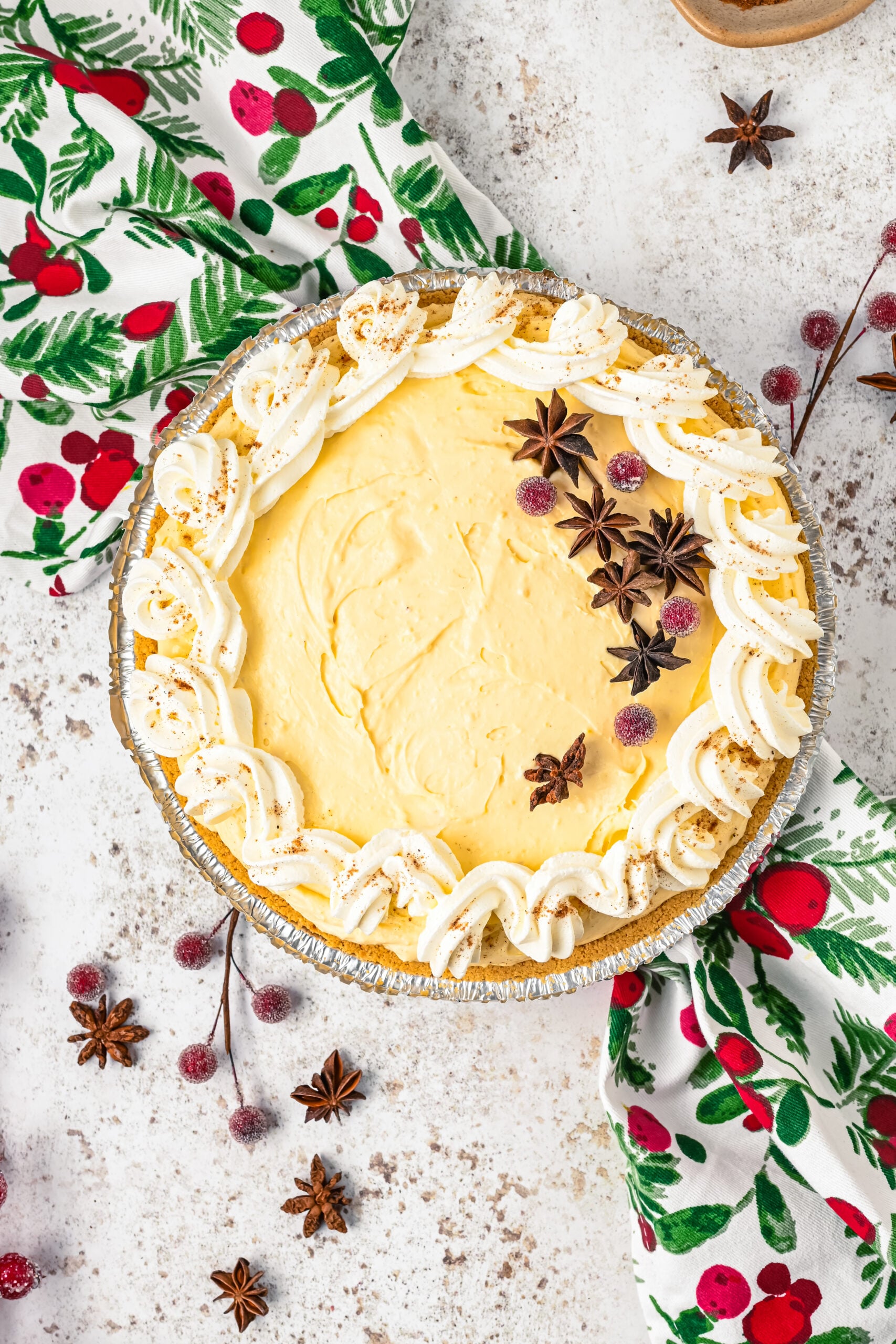 Overhead view of the pie topped with sugared cranberries and star anise.