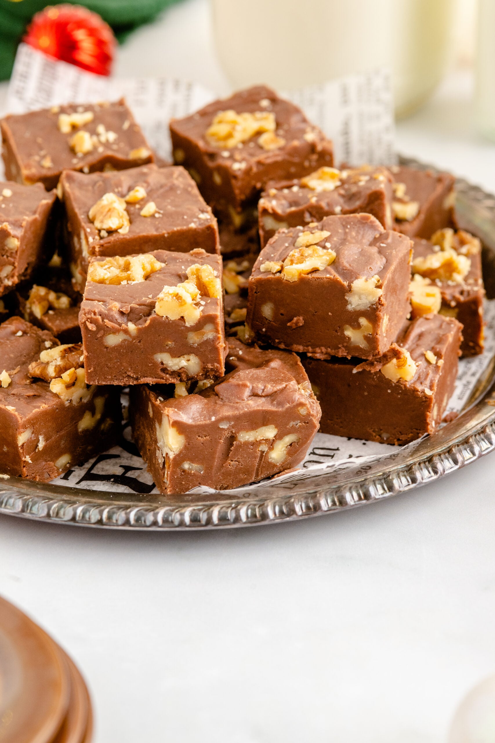 Fantasy Fudge stacked on a tin serving tray with twinkle lights in the background.