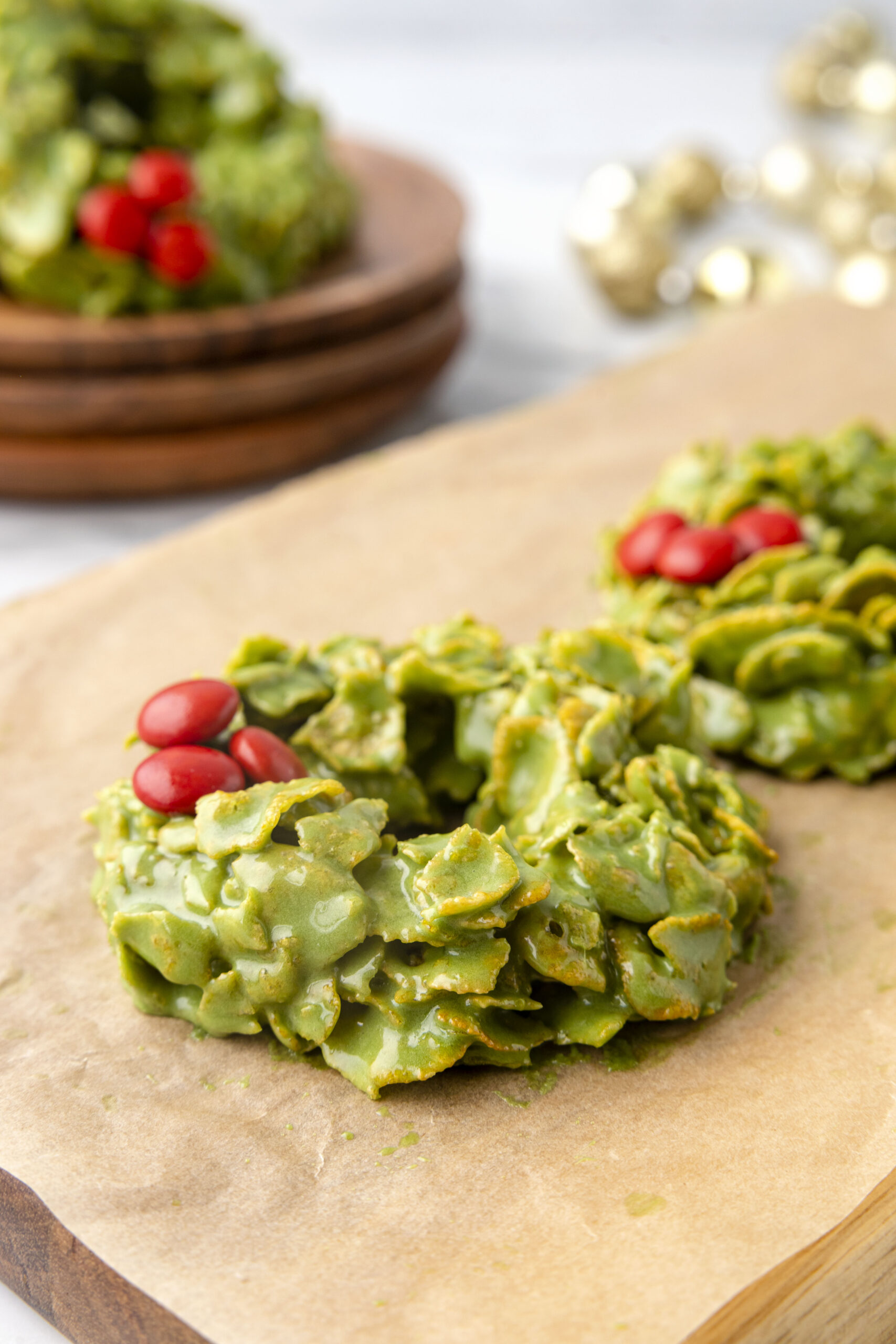 Side view of cornflake wreaths on parchment paper.