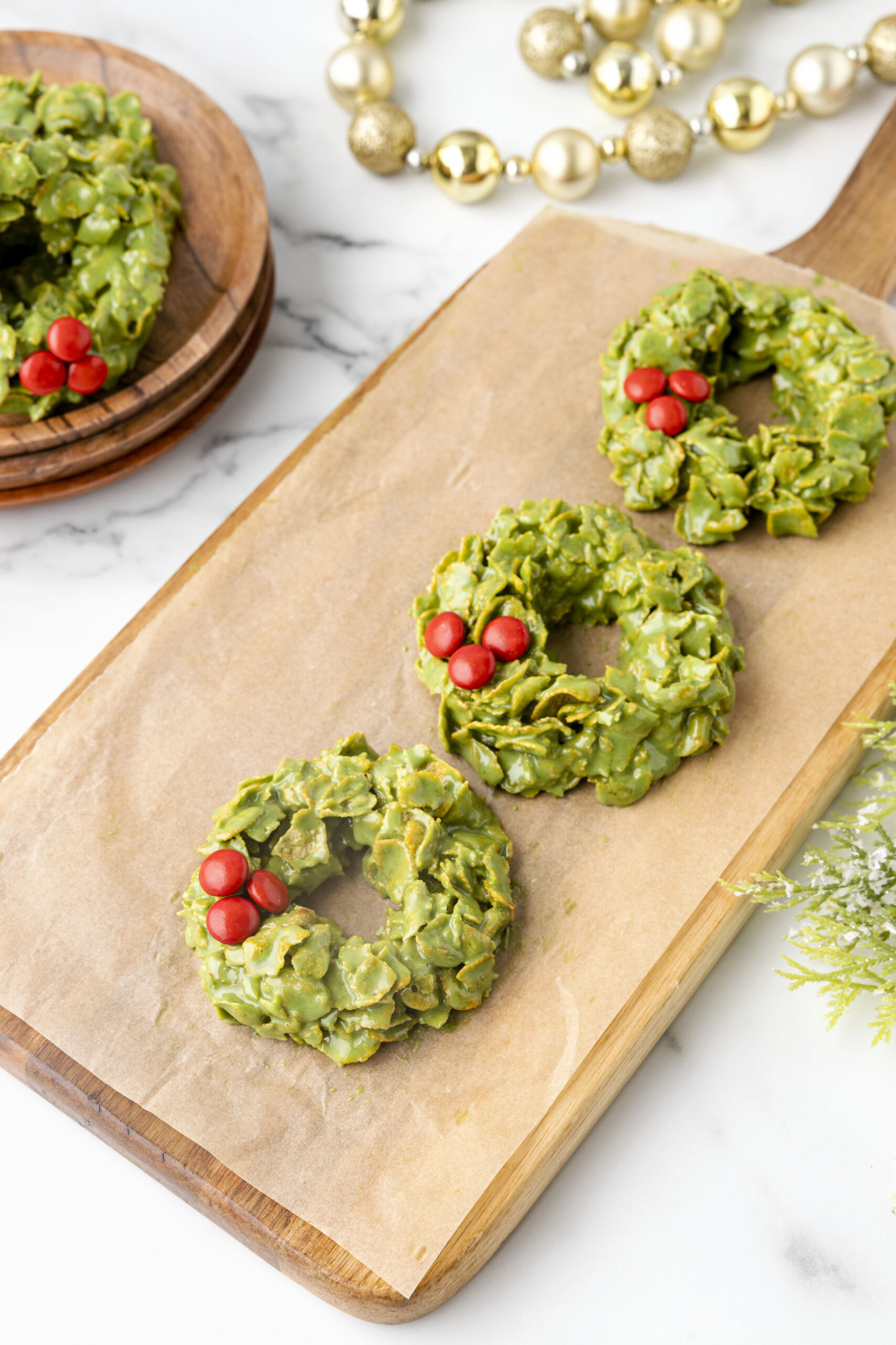 Three wreaths on a wood serving tray.