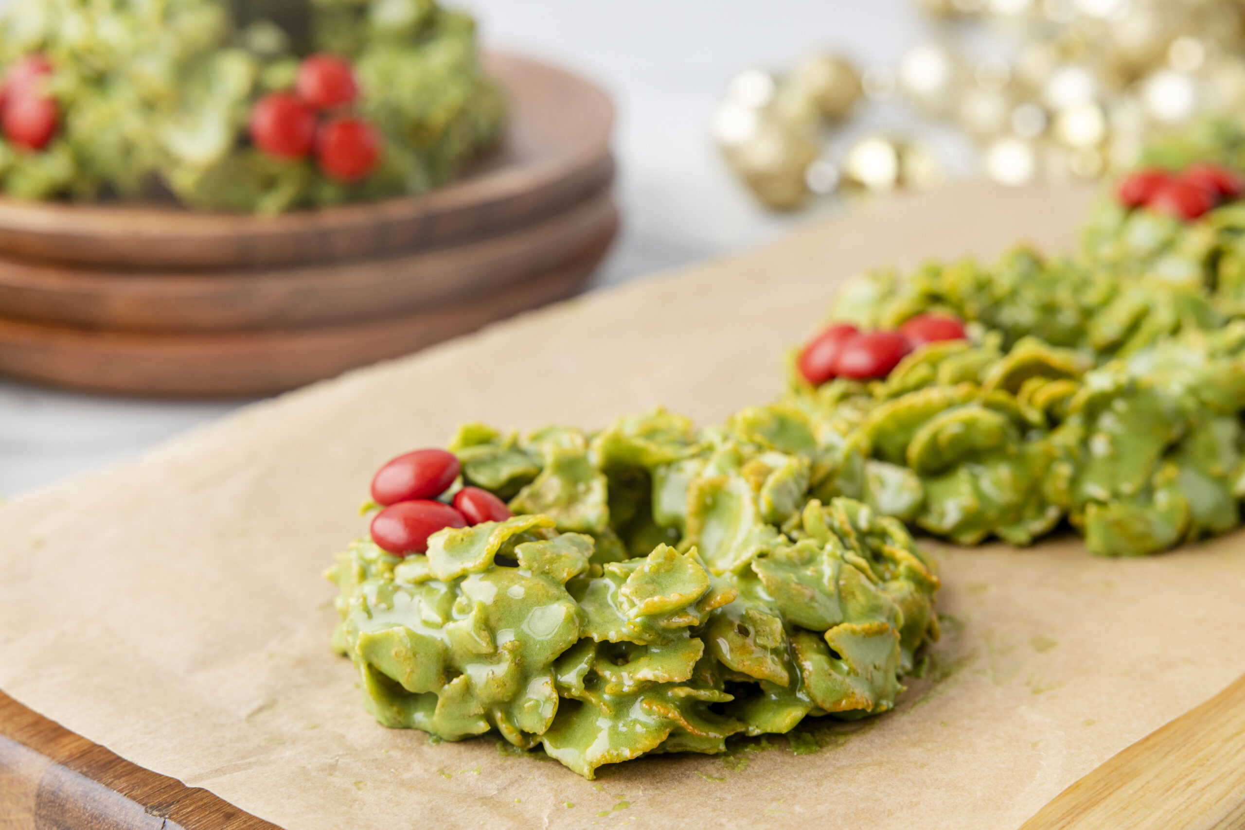 Side view of cornflake wreaths on parchment paper.