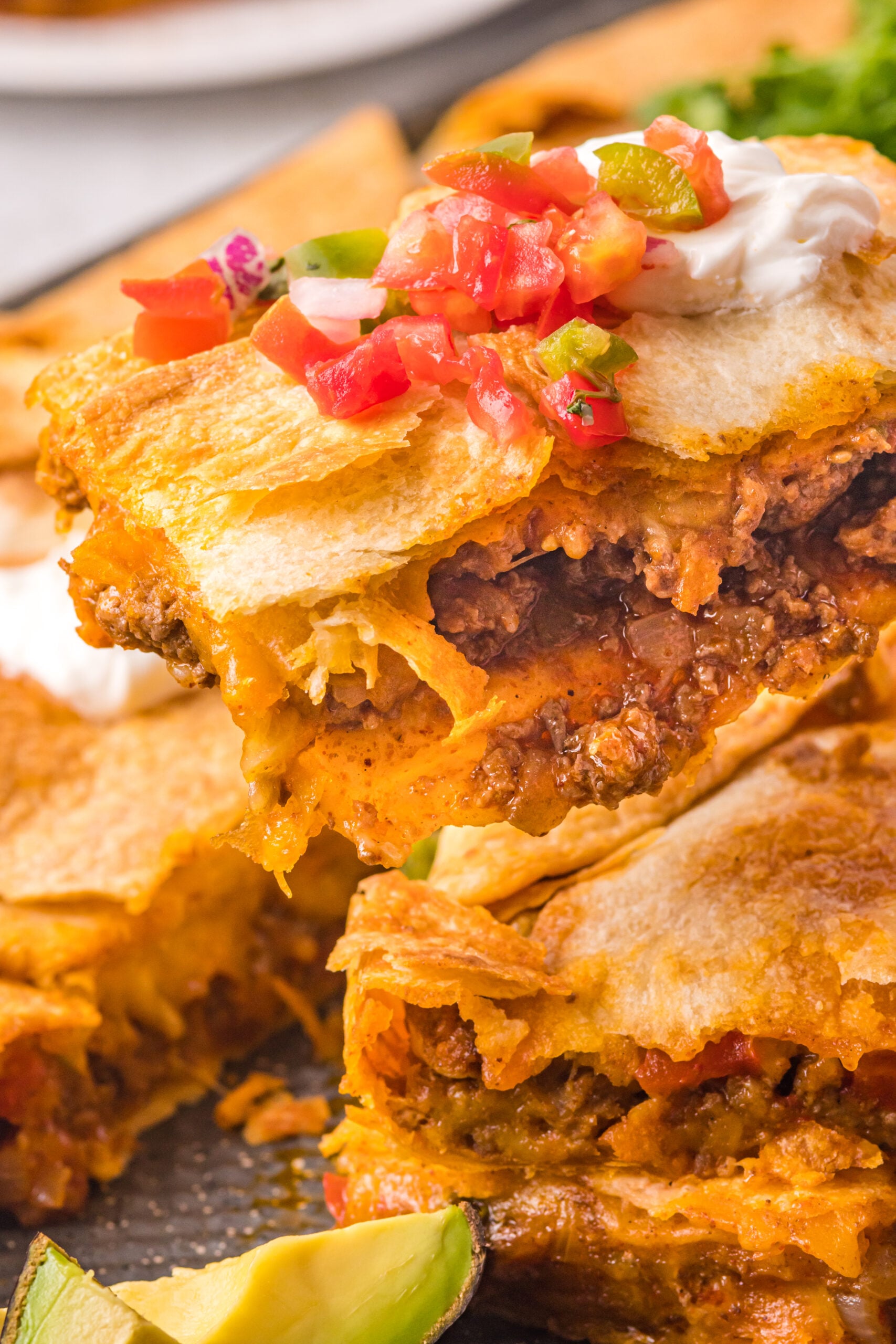 A piece of sheet pan taco being removed from the baking sheet. 