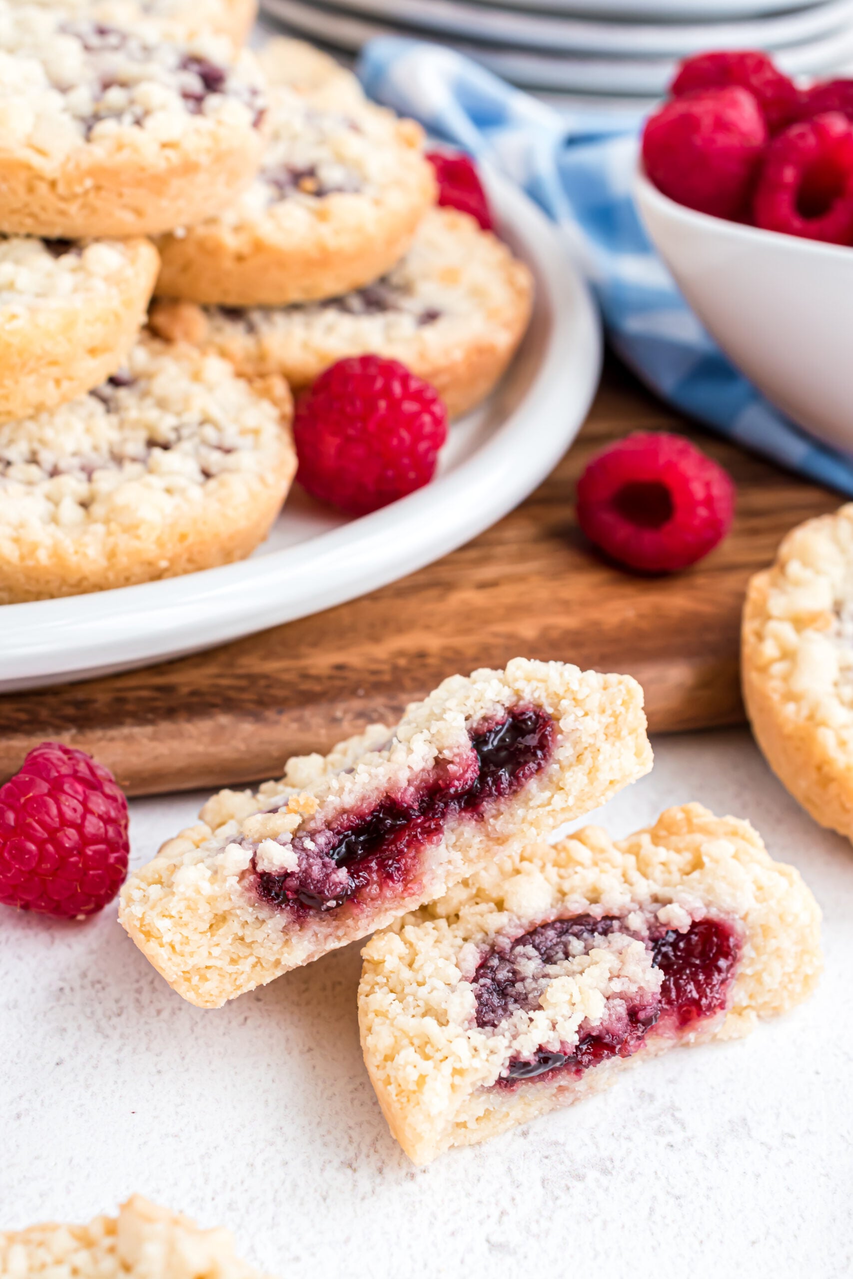 A raspberry cookie cut in half showing the raspberry filling center.