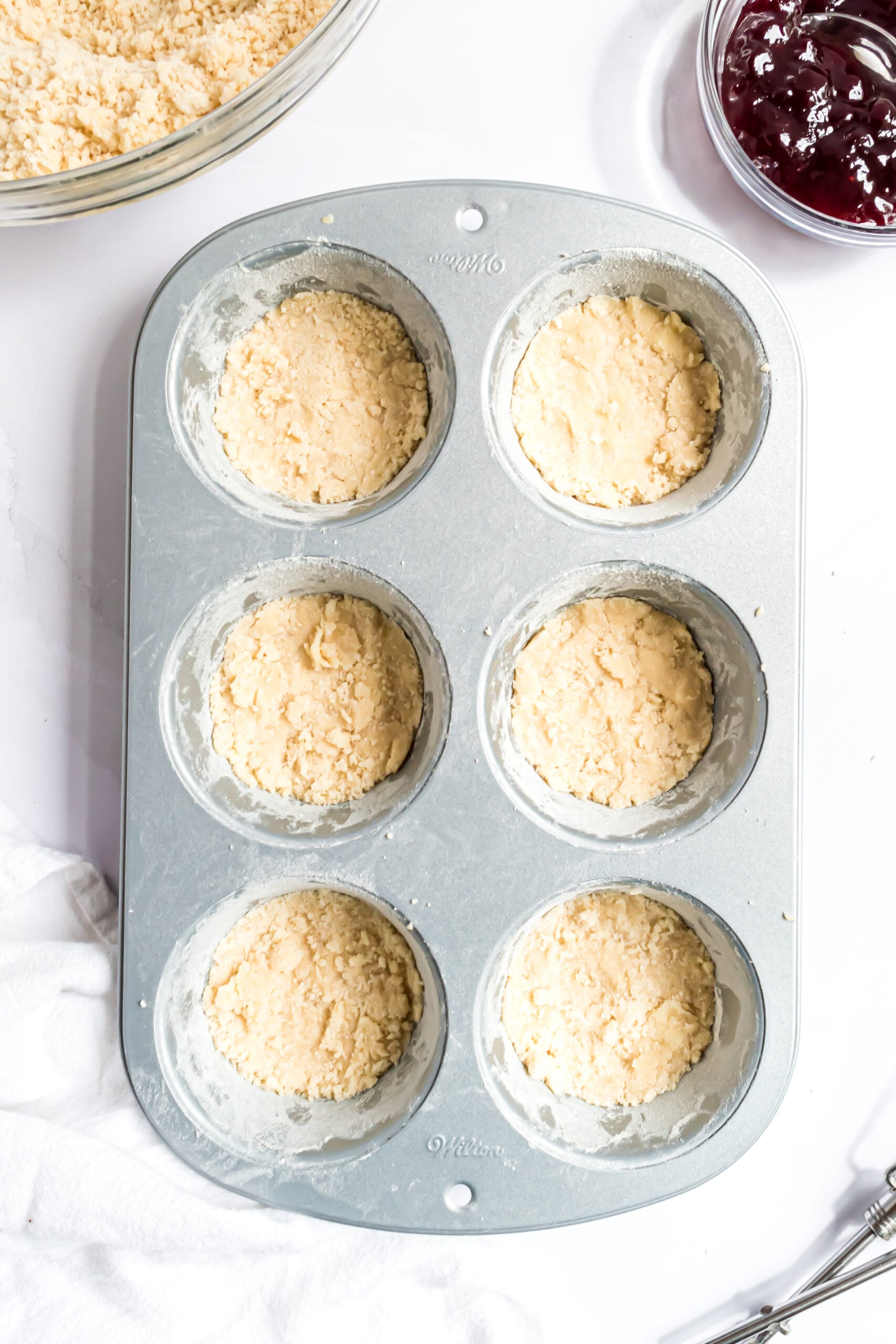 Overhead shot of the crust in a muffin tin.