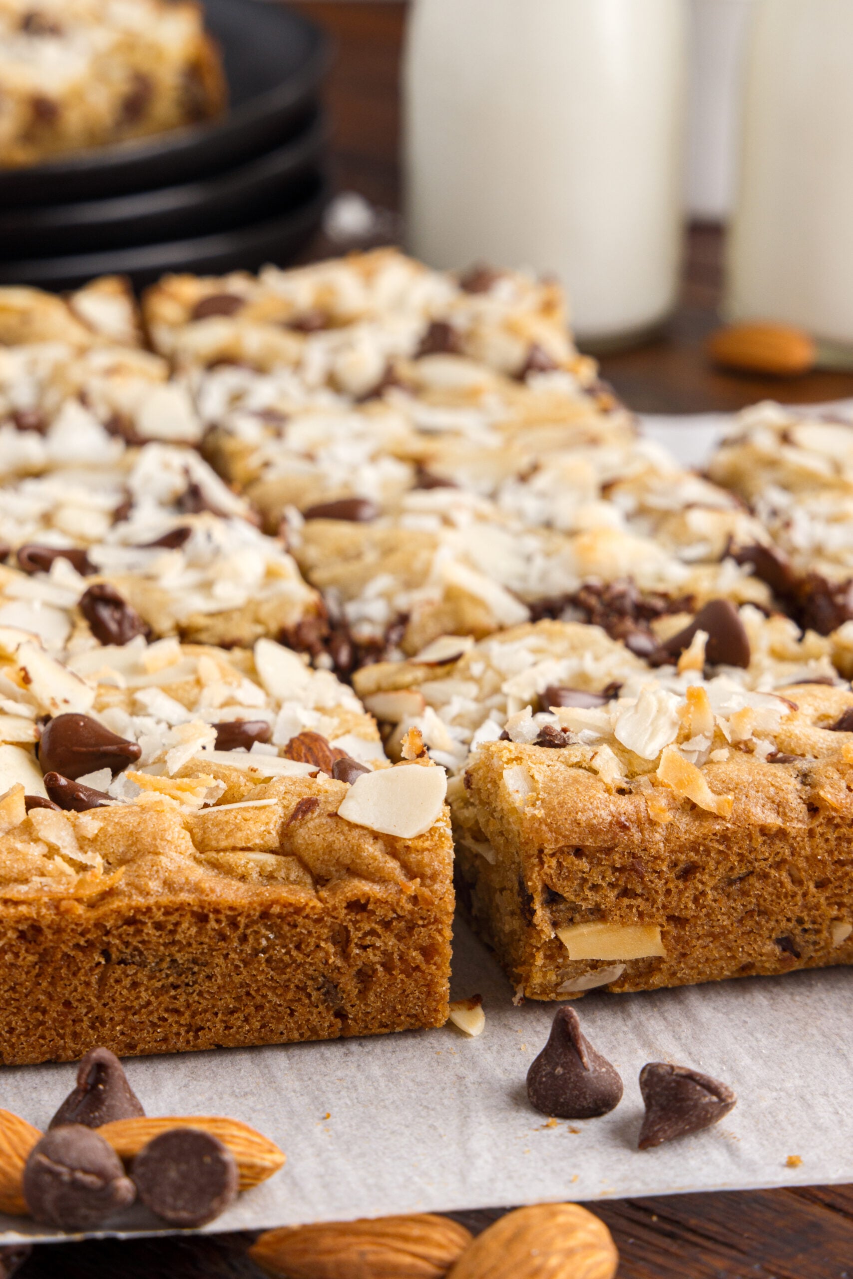 Side view of the almond joy cookie bars on a piece of parchment paper.