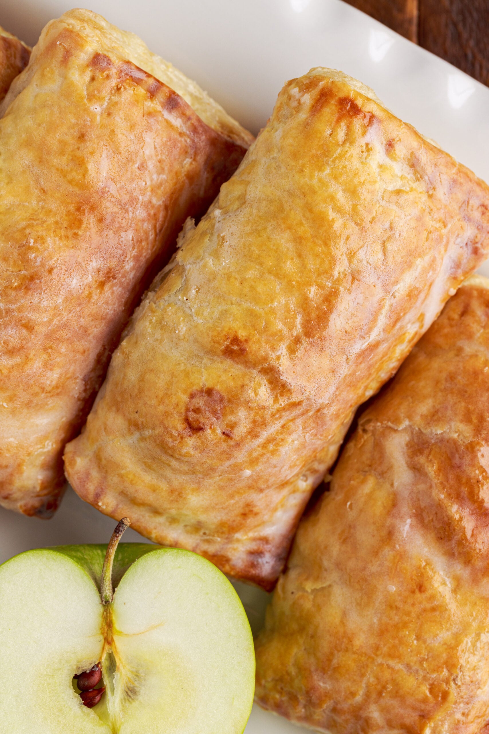 Overhead view of an apple hand pie showing the glaze and golden brown crust.
