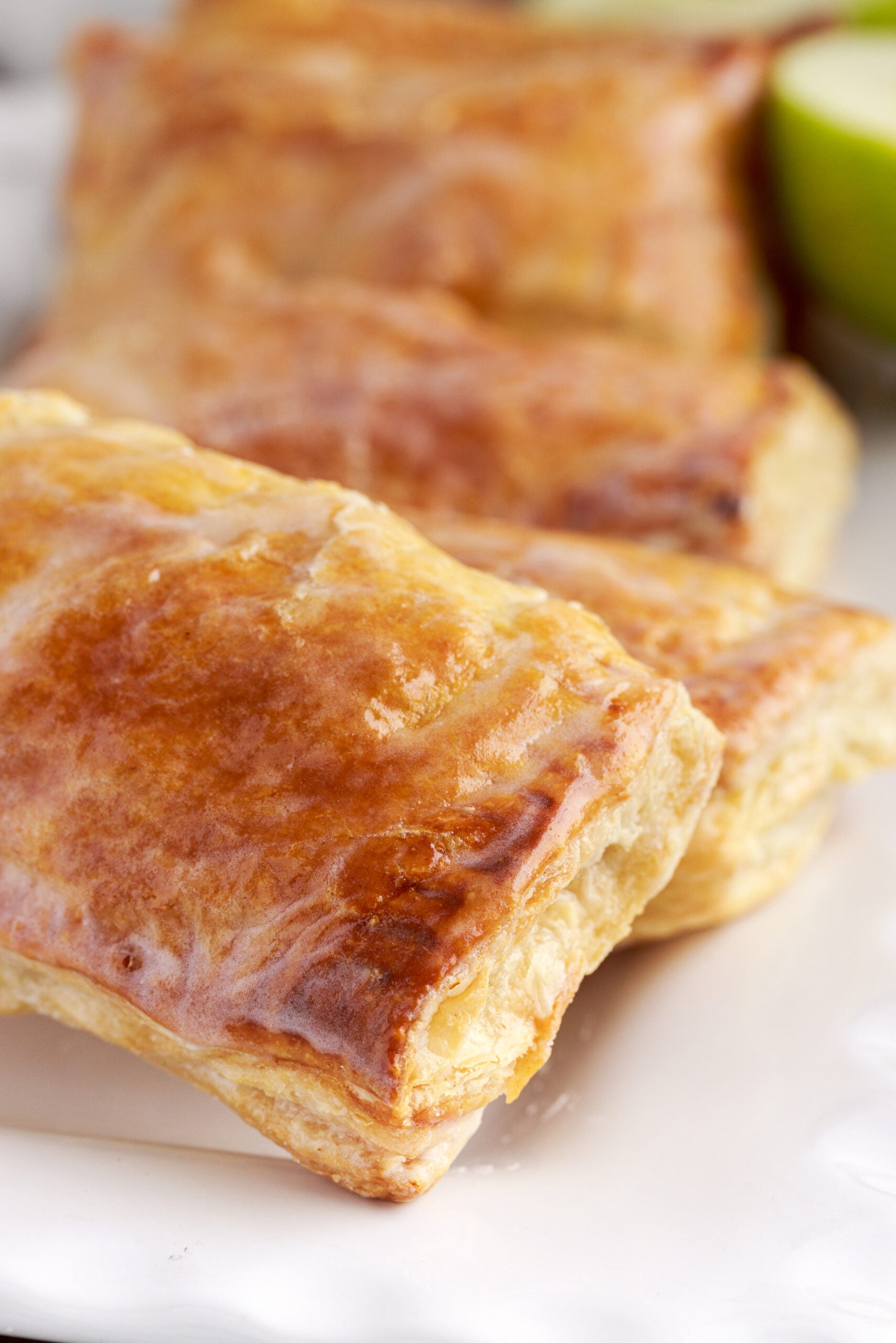 Overhead view of an apple hand pie showing the glaze and golden brown crust.