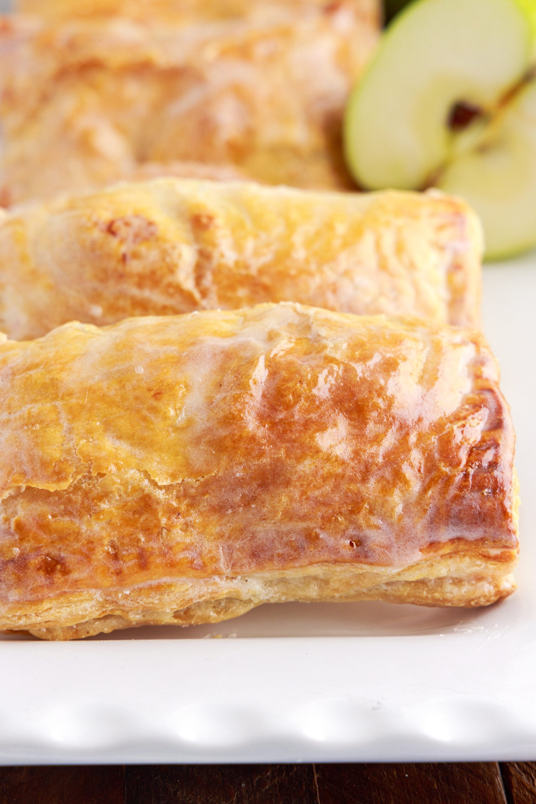 View of an apple hand pie showing the glaze and golden brown crust.