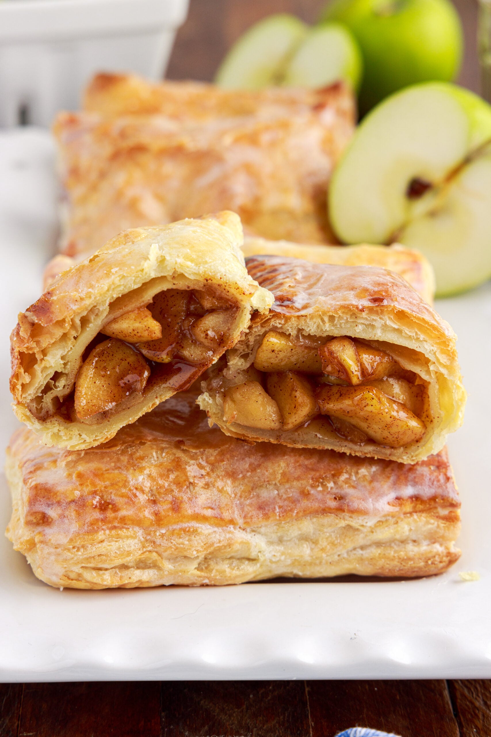 An apple hand pie cut in half showing the filling on the inside.