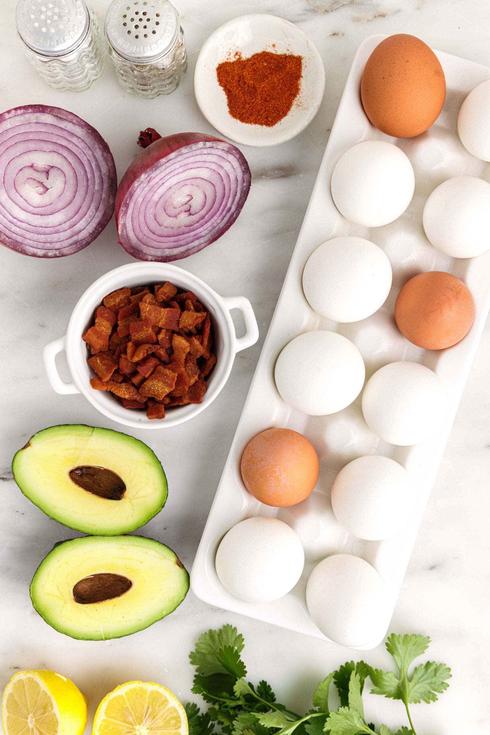 Overhead view of ingredients needed to make avocado deviled eggs.