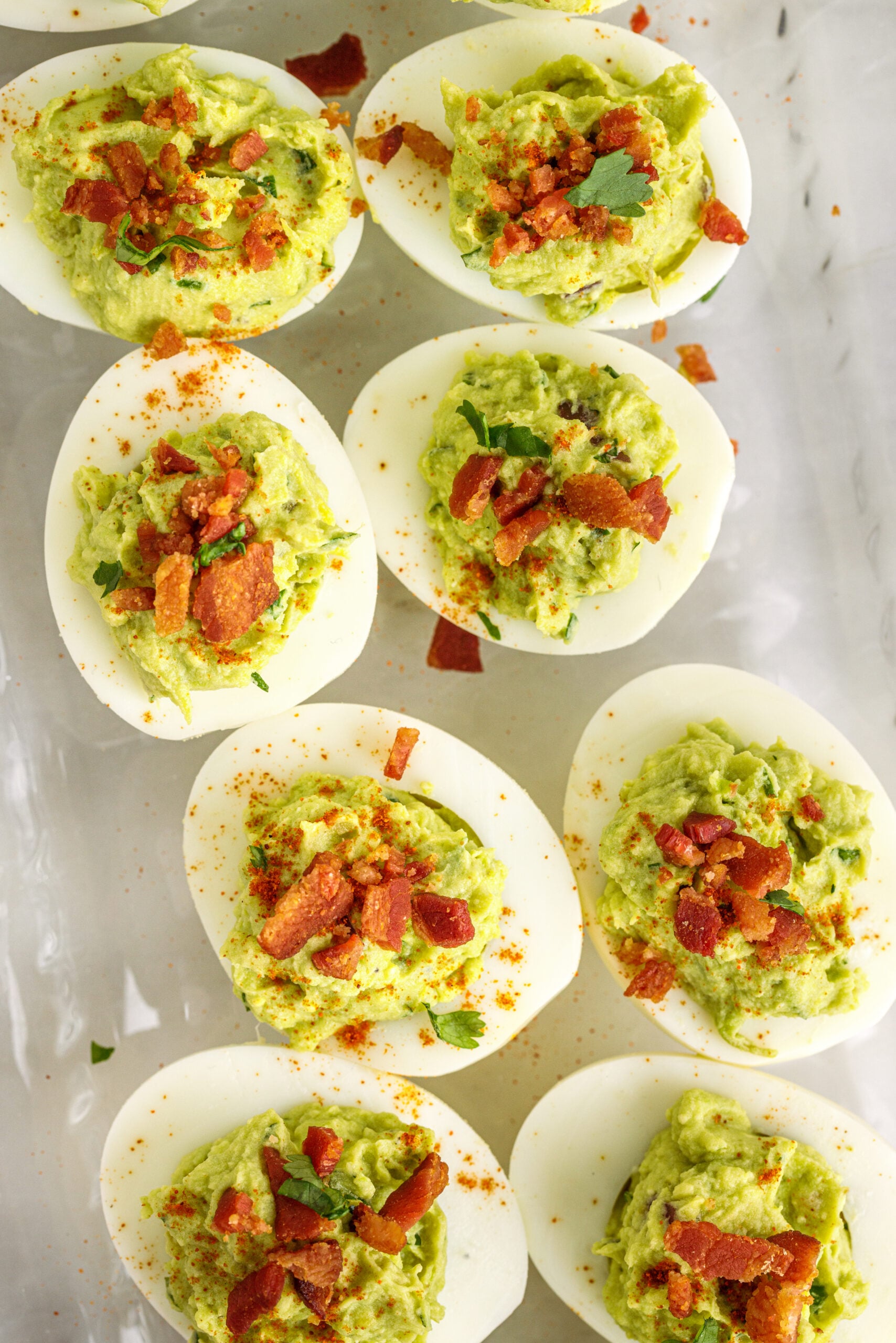 Overhead view of the deviled eggs topped with with chopped bacon.