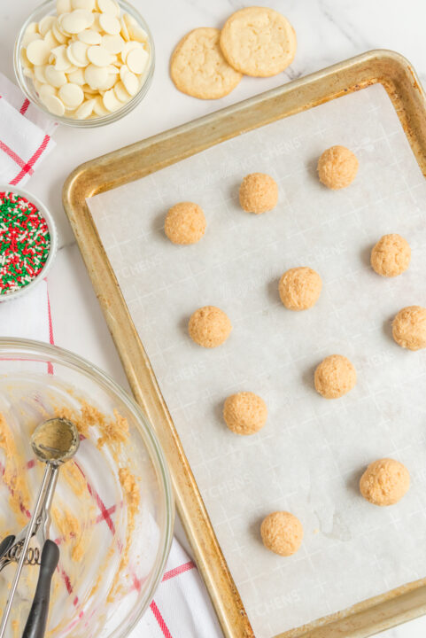 Overhead shot of the dough being shaped into balls and placed on a baking sheet.