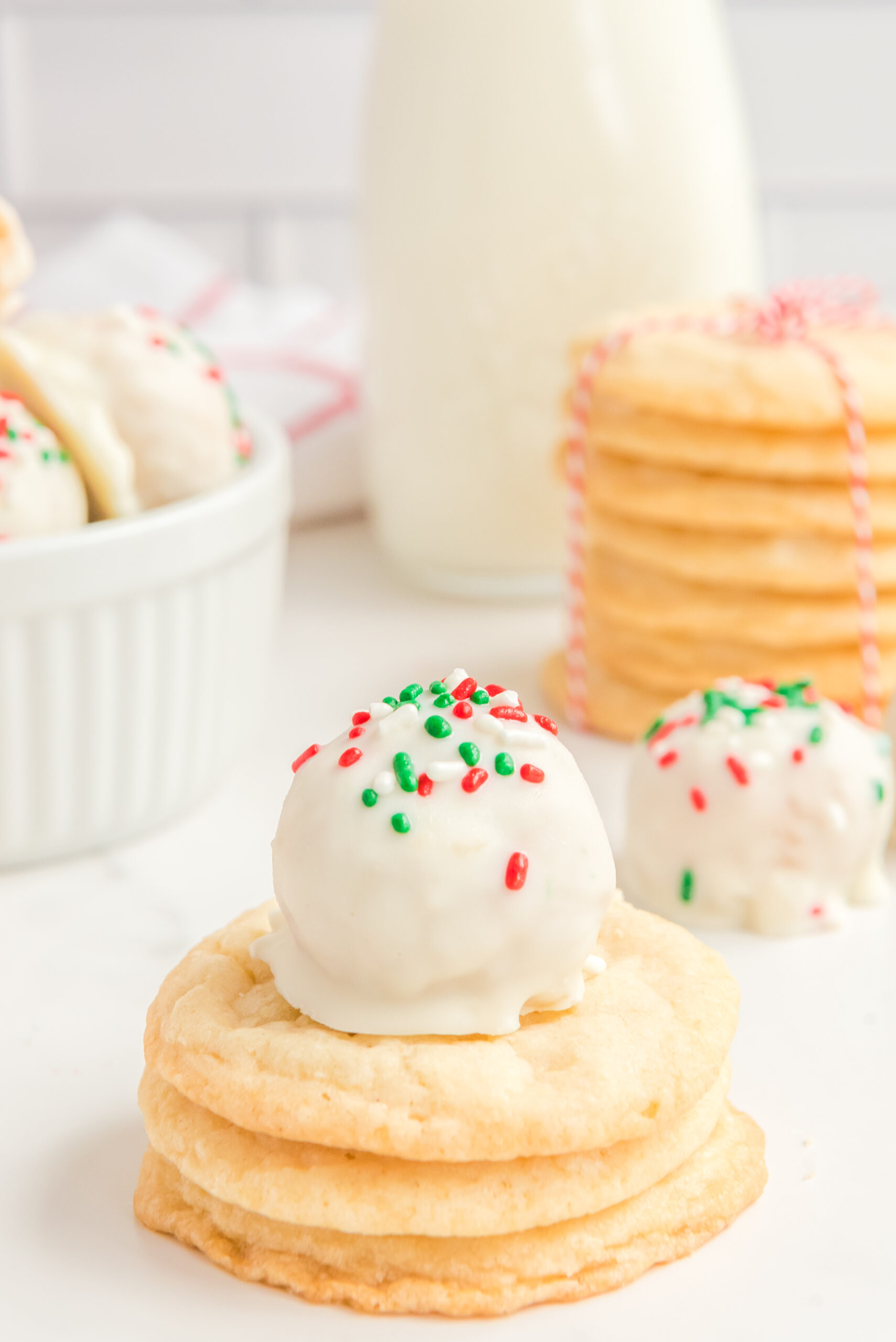 A sugar cookie truffle stacked on top of three sugar cookies.