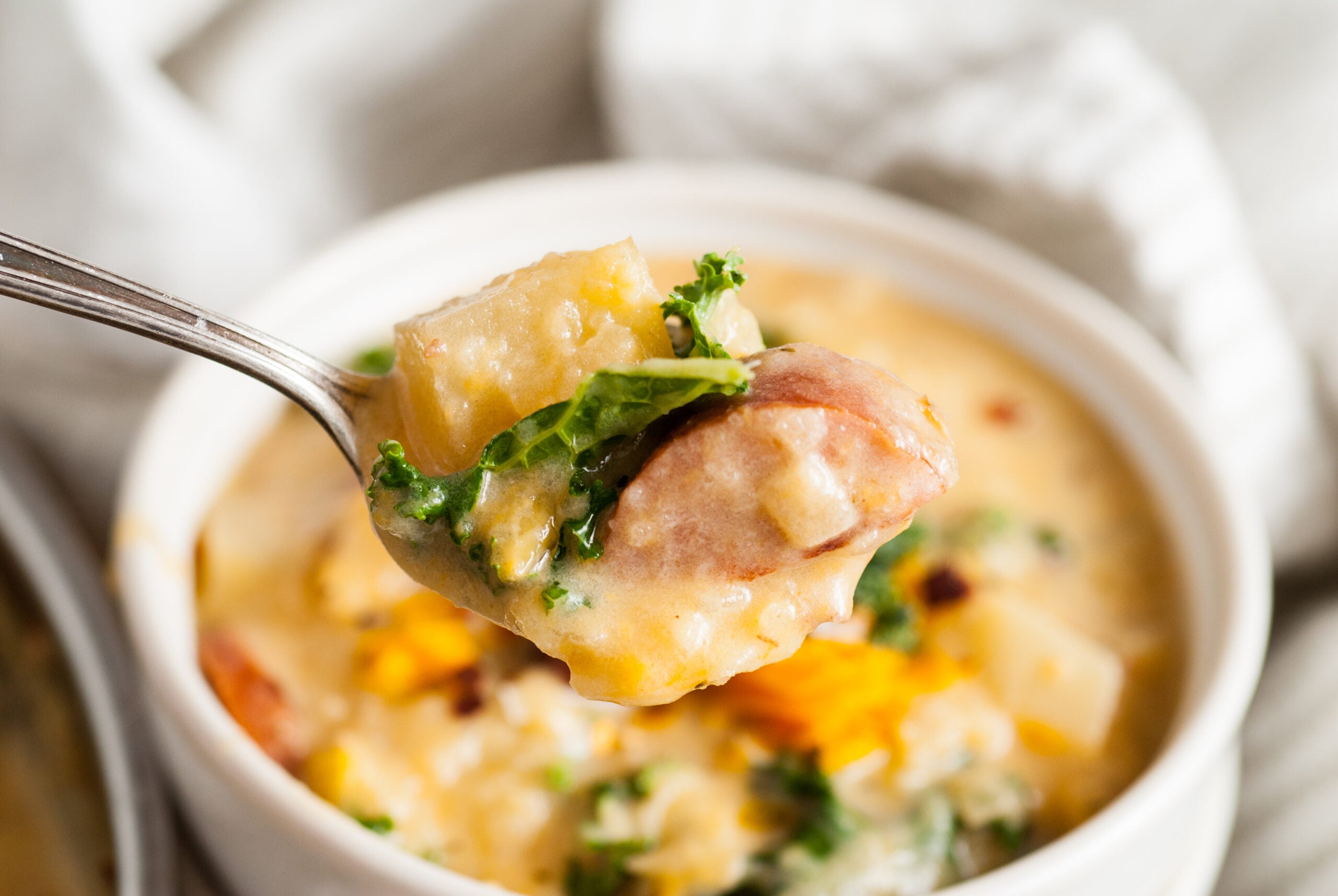 A spoon full of soup showing a close up of the ingredients. 