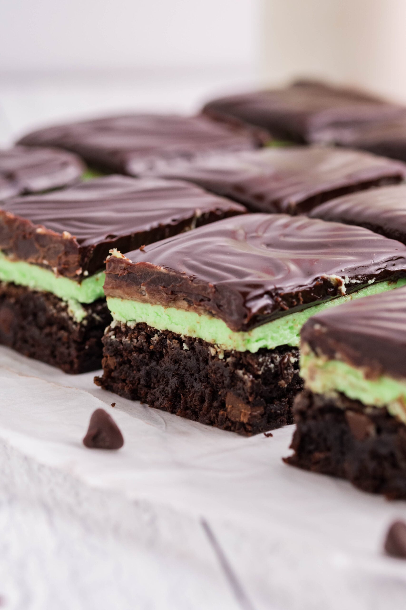 Side view of the brownies showing the brownie, mint frosting, and chocolate layers.