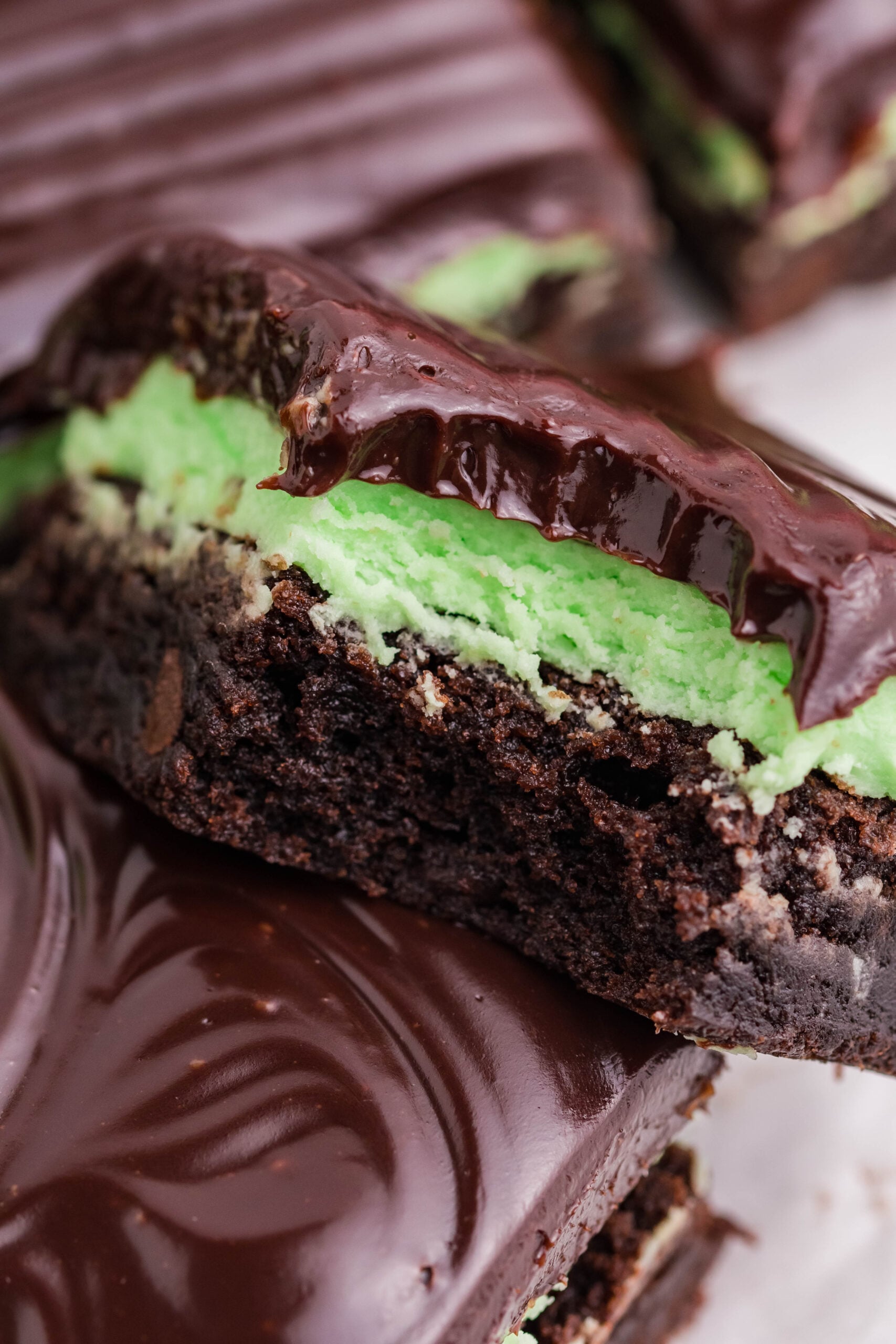 A brownie stacked on top of another with a bite removed.
