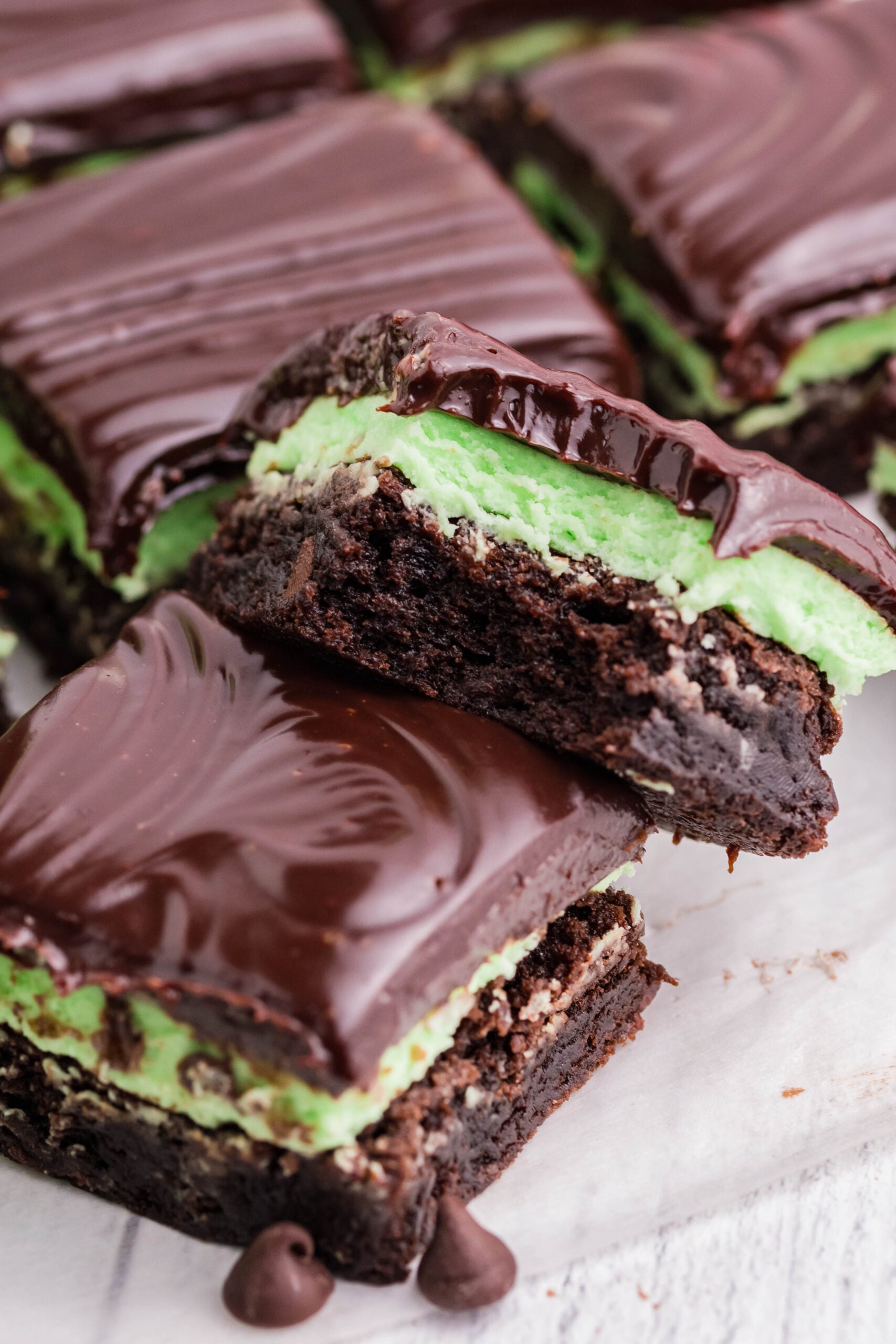 A brownie stacked on top of another with a bite removed.