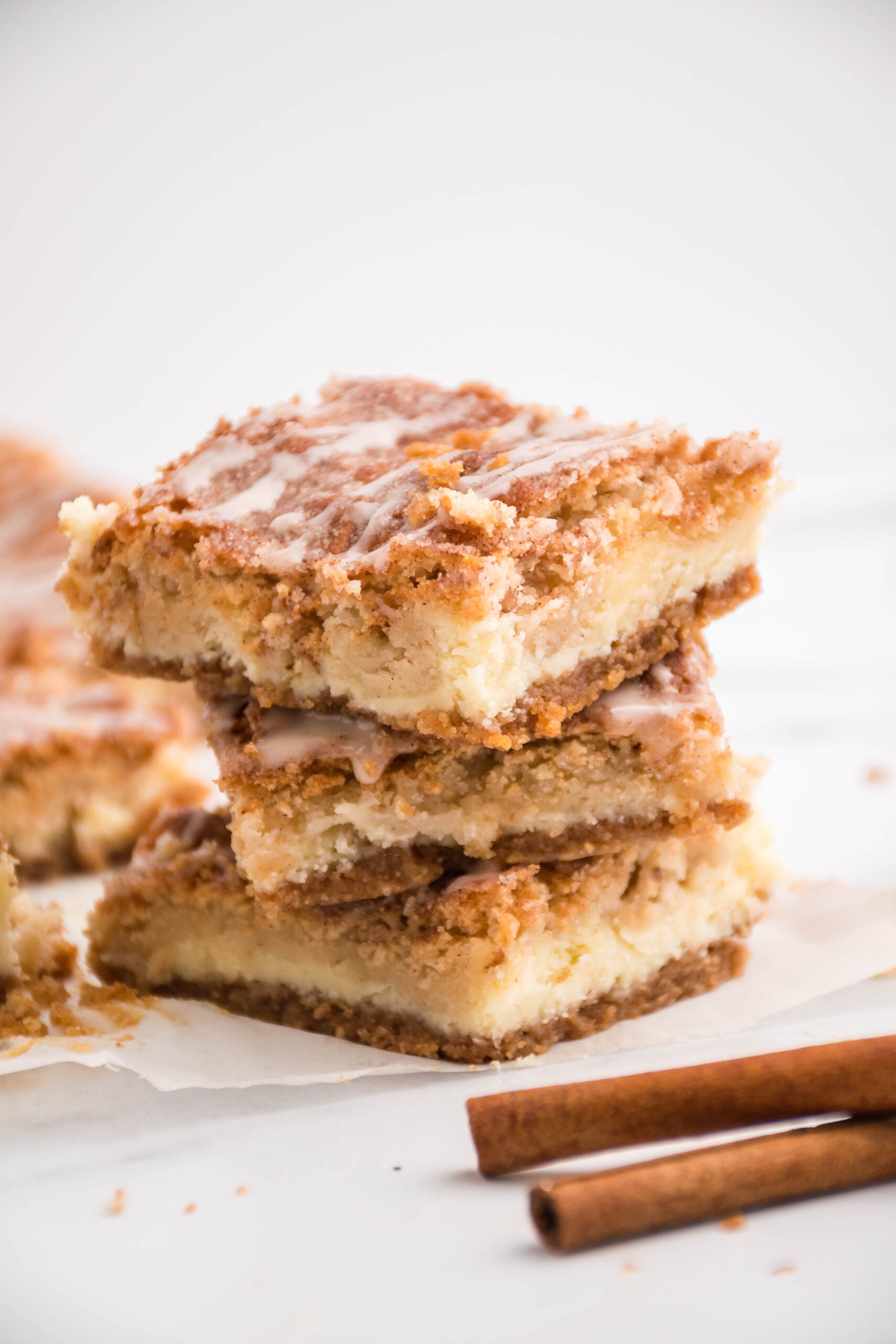 Three cheesecake bars stacked on top of each other.