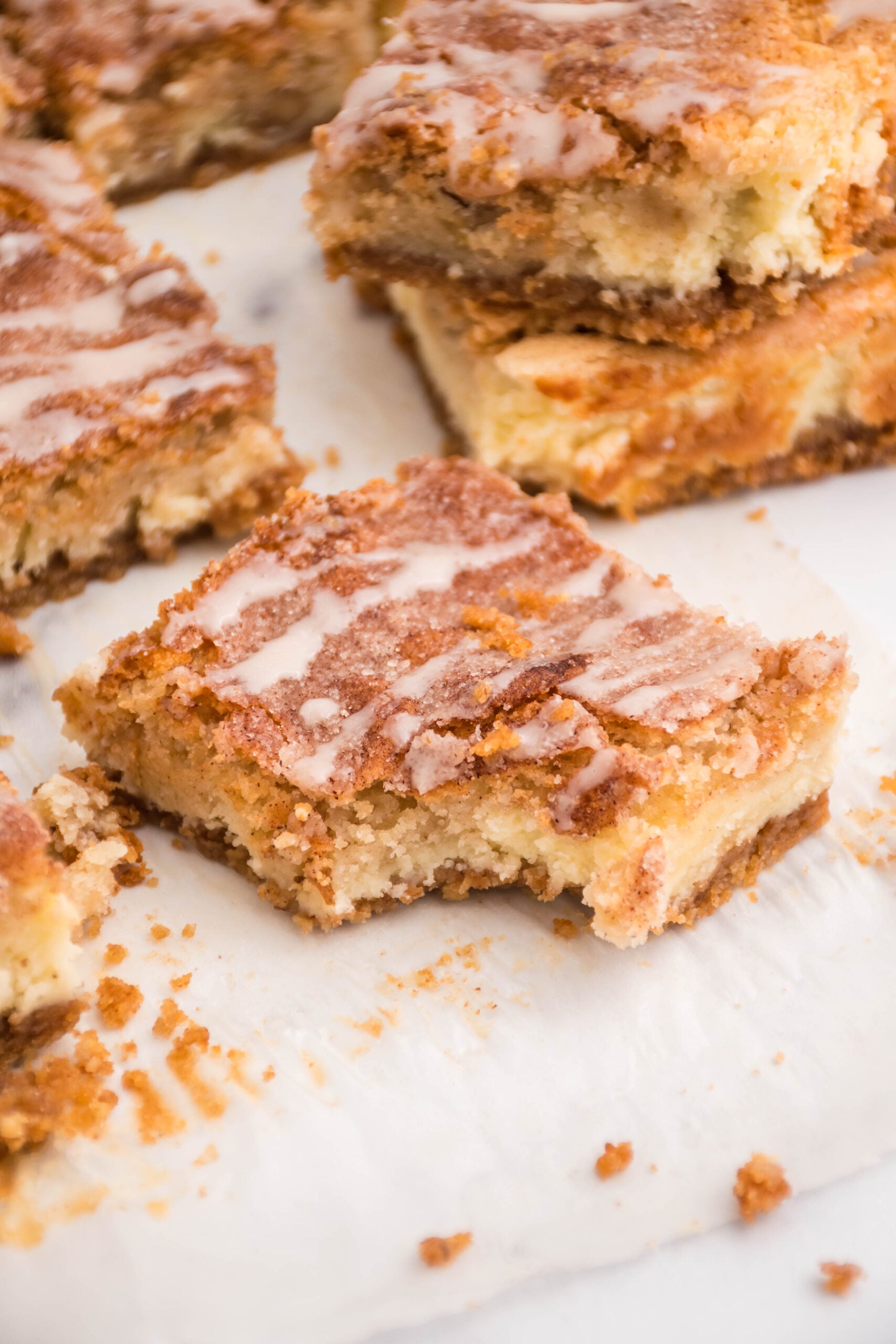 Up close view of a bite removed from a cheesecake bar.