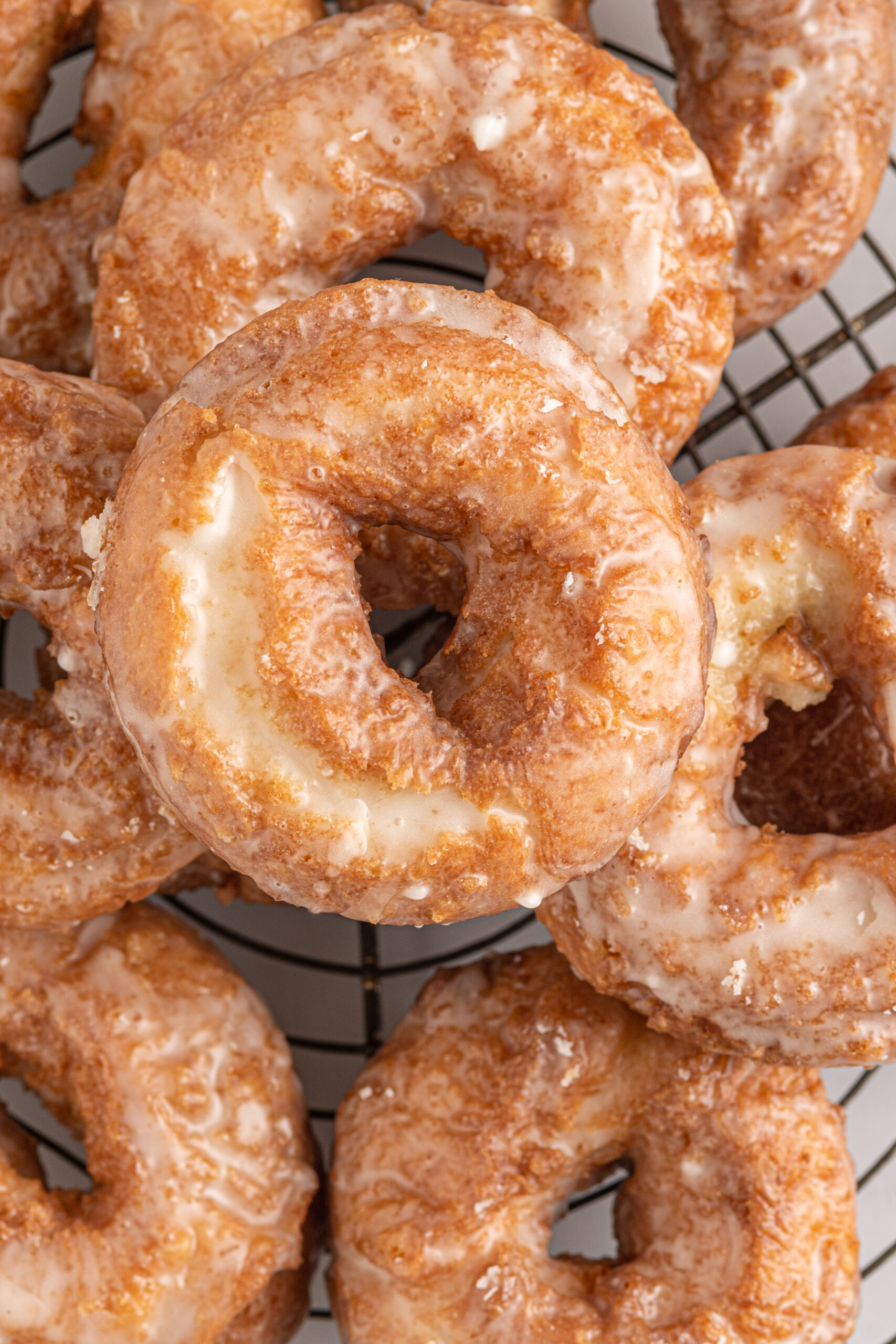 Overhead view of the old fashioned donuts on a wire rack.