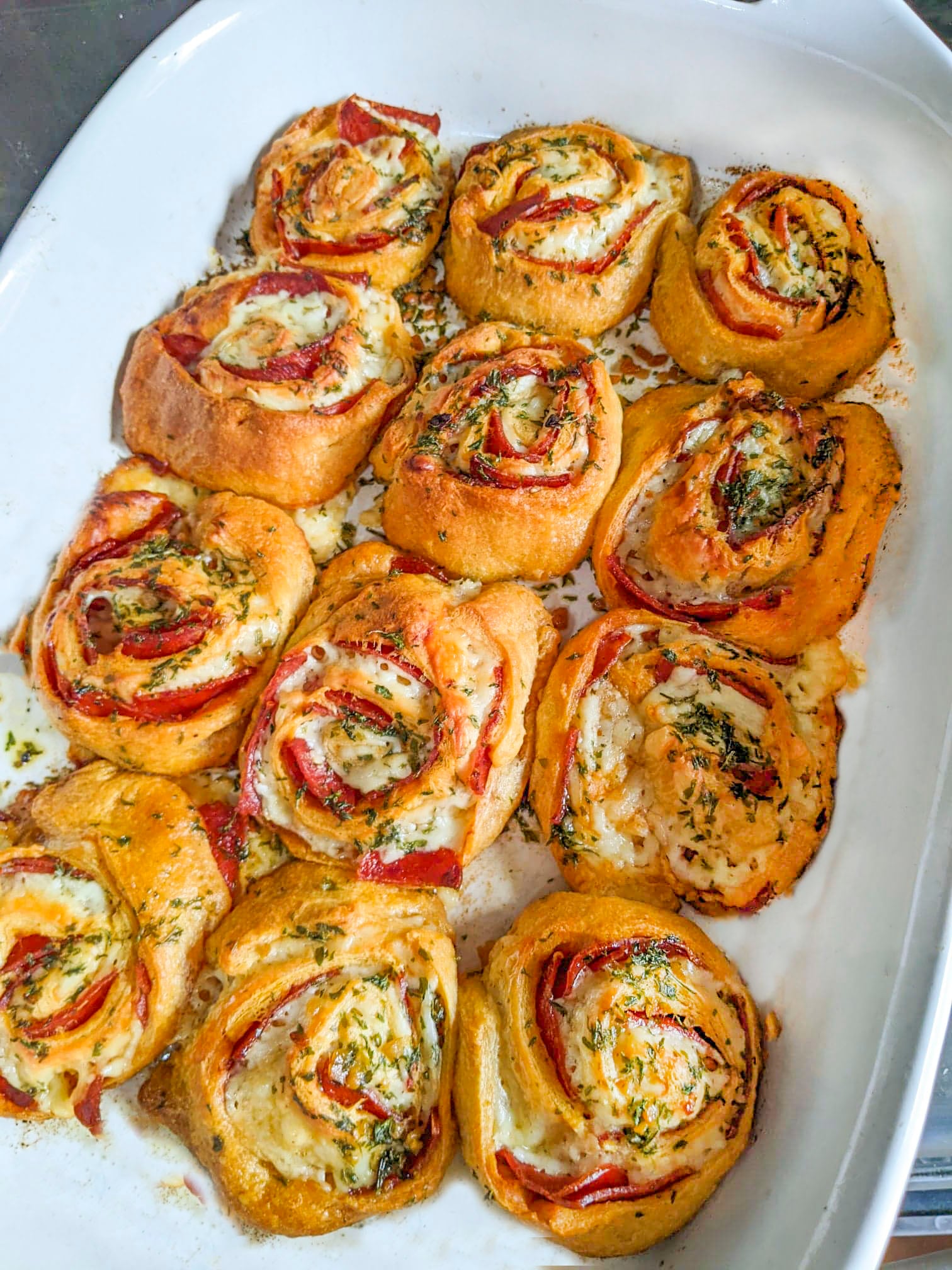 Pizza pinwheels in a white baking pan